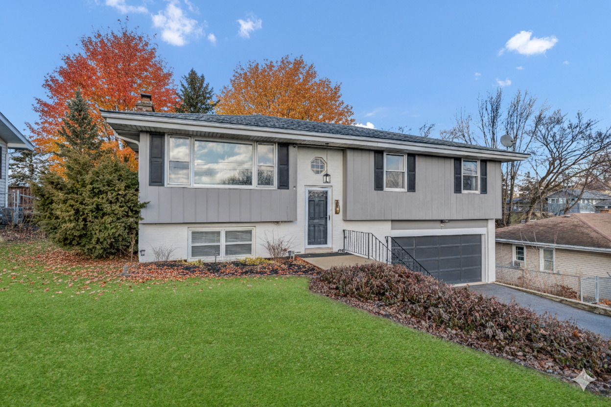 **Back on the market due to buyer getting cold feet and walking away prior to inspection - Beautifully updated and well maintained, this 3-bedroom 2.5 bath raised ranch in desirable Lake in the Hills Estates feels welcoming from the moment you arrive. From the inviting entryway, step up to a spacious and bright living room that opens to the dining area with a slider to the patio-perfect for everyday living and entertaining. The updated kitchen boasts stainless steel appliances and range hood, a separate cooktop and built-in oven, white cabinetry, tile backsplash, and a planning desk. Convenient half bath for guests too! Down the hall is the primary bedroom with an en-suite bath and two additional bedrooms. The finished walk-out lower level offers a large family room with a cozy stone fireplace, projector and screen are included and are perfect for movie nights, and a slider to the outdoor space, plus a full bath and laundry room with sink. Great outdoor space with a deck that leads to a hot tub overlooking the fenced yard.  Shed for extra storage. Ideally located near Randall Road, shopping, and restaurants, this home truly checks all the boxes.