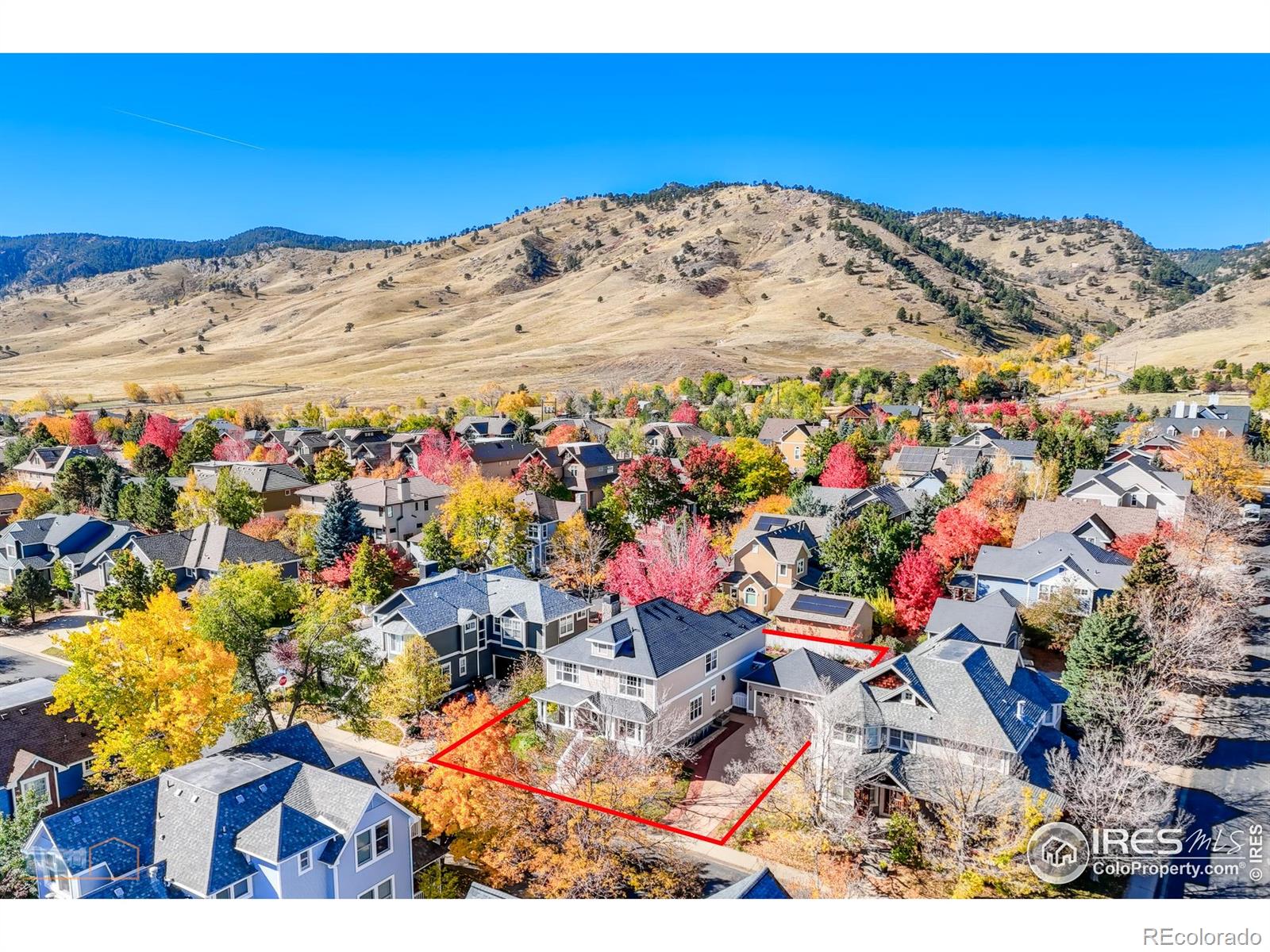 This irresistible Four-Square blends timeless charm with modern Colorado living. Perfectly placed on a generous fenced lot (in "original" Dakota Ridge where the yards are large), it's just a block from the neighborhood park and scenic hiking and biking trails of Boulder's stunning foothills. A gracious covered porch sets the stage, drawing you into open spaces where a wall of windows flood the kitchen and living areas with sunlight. In addition to a cozy living room and chef's kitchen (enhanced with a Wolf oven/range, stone countertops, ss appliances and adjacent laundry/mudroom), the main level offers a welcoming foyer, formal dining, private office, and half bath, all wrapped in understated elegance. Upstairs, discover a rare four-bedroom layout, including a serene primary suite with 5-piece bath and views, plus walk-in closets in every room. The fully finished, permitted basement adds versatility: a large rec room, guest suite, and a flexible office or sixth bedroom. Surrounded by mature trees, a large stone patio, raised beds and anchored by a two-car garage, this home is as practical as it is captivating. More than a house, it's a feeling!