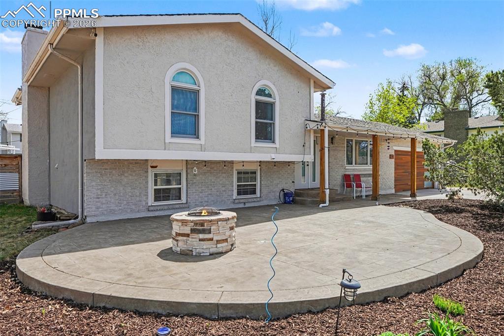 Beautifully renovated and full of charm, this rare find blends classic character with modern updates in a quiet neighborhood with larger lots, mature tree-lined streets, and minimal traffic. The exterior was refreshed with new stucco in 2022, and the home is even pre-wired for a hot tub.Inside, the main level has been opened up to create a bright, airy great room with hand-scraped floors. The gourmet kitchen features granite slab countertops, an island, newer cabinetry, updated appliances, and modern lighting. The reimagined primary suite offers a spa-like retreat with custom tile, dual vanities with quartz counters, and an oversized shower with bench and seamless glass. The additional upstairs bath has also been tastefully remodeled with tile flooring, updated fixtures, and a pedestal sink.The lower-level family room includes laminate wood flooring, a wood-burning fireplace, an additional 3/4 bath, and a generous living space with walkout access to the backyard. Outside, enjoy a huge private yard with cozy patio spaces, a large patio with fire pit, full fencing, plenty of room to play, and a charming stage/sitting area.The basement adds even more flexibility with a large bedroom, craft room, spacious storage area, and carpeted floors. Additional highlights include many newer windows, furnace approximately 10 years old, central A/C, and a radon mitigation system. Located in desirable D-20 schools.Measurements are approximate. Buyer to verify all measurements.