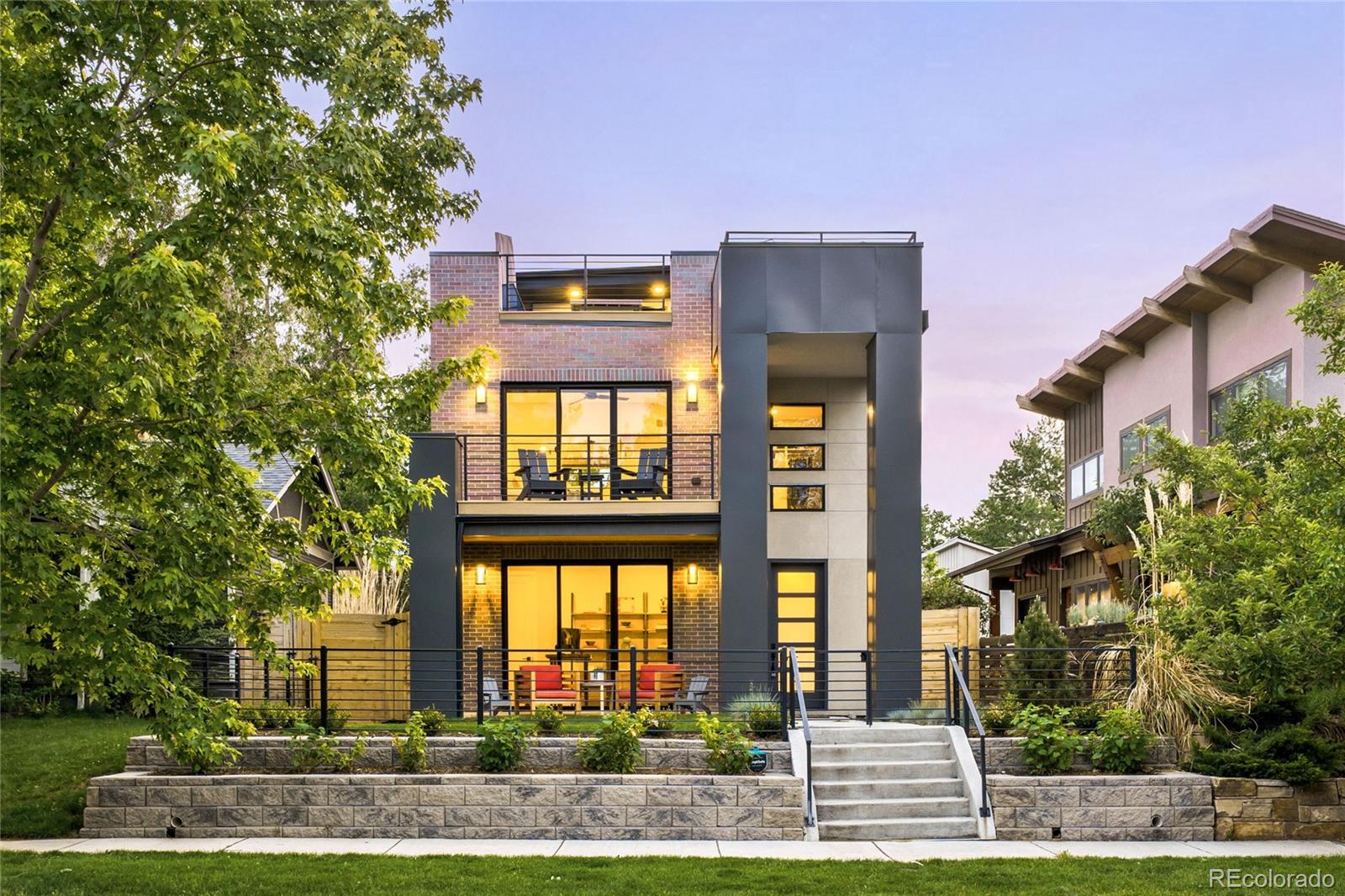 Completed in 2021, this extraordinary University Park residence represents the pinnacle of modern luxury living. Meticulously curated by a single owner, the interior impresses with an open-concept layout adorned with high-end finishes and soaring ceilings. The gourmet kitchen showcases a large center island and premium appliances. Multiple fireplaces and wet bars are woven throughout the home, and a main-level office with sliding doors to the outdoors adds refined versatility. The primary suite delivers a spa-inspired bath and generous walk-in closets, while a fully finished basement with tall ceilings, flex space and additional accommodations expands the home's versatility. Over $115k in exterior enhancements — including mature landscaping, a pergola, French drain, epoxy garage flooring with overhead storage and a freshly painted exterior — create an exceptional outdoor sanctuary. A rooftop deck with a firepit and sweeping views, a detached three-car garage and a whole-home water filtration system complete this remarkable offering near Washington Park and Pearl Street.
