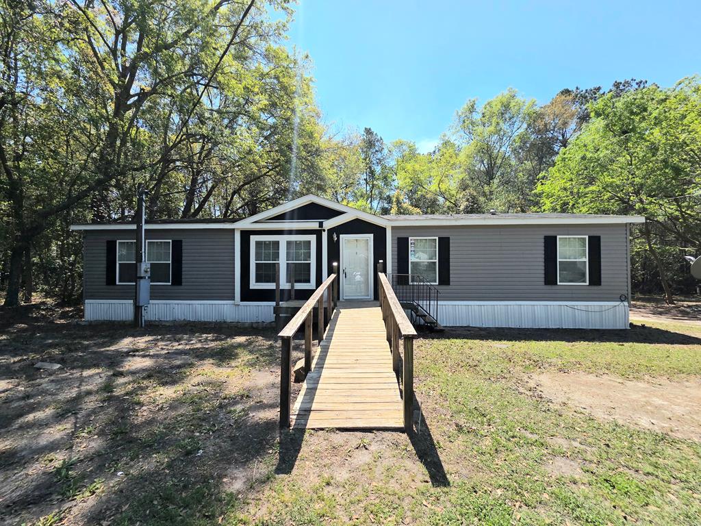 In the heart of Boston, GA, this 3-bedroom, 2-bath mobile home is waiting to be discovered. Offering an expansive open floor plan, this residence provides a blend of comfort and style perfect for modern living. Step inside to find a generous living room area that seamlessly flows into a kitchen that stands as the centerpiece with its impressive island and bar, promising functionality along with ample workspace for cooking. An adjacent formal dining area invites memorable meals with family and friends from the dining area you can flow right into the large den area. Beyond the main living areas, you'll appreciate the primary bedroom and bath with it's soaking garden tub and separate shower. Backyard includes a storage building.