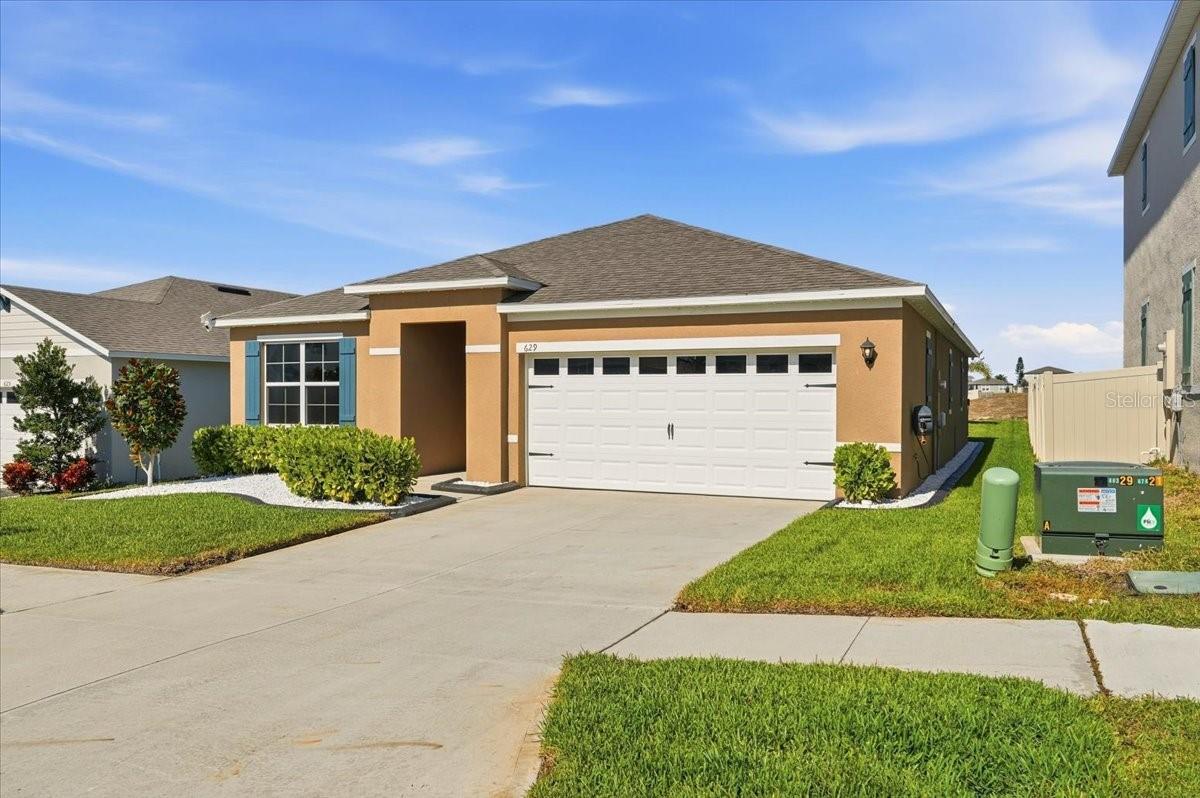 One or more photo(s) has been virtually staged. Looking for that new home without the wait of a new build? Welcome to your beautifully appointed 3-bedroom, 2-bath home in one of Lake Alfred’s newer communities! This modern residence blends comfort, style, and convenience, offering a bright open layout and access to fantastic neighborhood amenities including a community pool and playground.Step inside to an inviting open-concept living area centered around a spacious kitchen featuring granite countertops, stainless appliances, a large island, and plenty of cabinet space—perfect for everyday cooking or entertaining with ease. The living and dining areas flow seamlessly and offer wonderful natural light.The split floor plan provides privacy, with a large master suite complete with a generous walk-in closet and an en-suite bath. Two additional bedrooms are well-sized and ideal for family, guests, or a home office.Relax on the rear lanai that overlooks the peaceful backside of the community, giving you a sense of privacy with no immediate rear neighbors. Whether enjoying your morning coffee or unwinding at sunset, this outdoor space is a highlight.  The yard is beautifully landscaped with custom curbing. Your new home looks beautiful at night with Govee Permanent Outdoor Lights which are completely programmable and adjustable through an app.Conveniently located near Auburndale, Winter Haven, the Polk Parkway, I-4 and an easy drive to Orlando, this home offers the perfect combination of modern living and small-town charm. With community amenities at your fingertips and a like-new home ready for its next owner, you won’t want to miss this one!  Call for your private showing today!