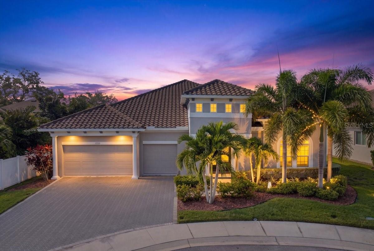 Located in Aberdeen Oaks, an intimate gated community of just 20 homes, this upgraded 2019 David Weekley Boulevard offers the rare combination of newer single-story living, an exceptionally functional floor plan and a premium cul-de-sac setting. Situated on one of the community’s original premium homesites, the home features 4 bedrooms, 3.5 baths, a 3-car garage and a tile roof. Ten-foot ceilings, 8-foot interior doors and generous windows give the interior an airy sense of scale and natural light. The expansive great room brings the kitchen, dining and living spaces together in a layout that works equally well for everyday living and entertaining. A massive quartz-topped island anchors the kitchen, complemented by abundant cabinetry, gas cooking, an upgraded LG Signature refrigerator and a separate dry bar with beverage refrigerator. Tray ceilings in the dining area, crown and chair molding, plantation shutters, custom built-ins, a fireplace and thoughtfully added lighting bring warmth and architectural character throughout. What truly sets the home apart is a floor plan that adapts beautifully over time. Beyond the great room, a separate wing offers two bedrooms, a full bath and its own retreat/living area, creating exceptional flexibility for guests, multigenerational living, a media or game room, hobby space or simply a second place to relax. A separate fourth bedroom with its own full bath provides another private space for guests or extended stays, while a dedicated study offers a quiet work-from-home option. The primary suite is equally well considered, with a tray ceiling accented by beams and a separate sitting area that can serve as an office, reading lounge or fitness space. The bath offers a soaking tub and separate glass-enclosed shower, while the professionally designed custom walk-in closet provides exceptional storage and organization. Since purchasing the home, the owners have invested more than $70,000 in post-construction enhancements, adding both style and everyday function throughout. A whole-house natural-gas generator, EV charger, water softener, additional fencing and other carefully selected improvements complement the extensive interior upgrades already in place. A dramatic 12-foot, three-panel sliding door opens the great room to the covered lanai, creating an easy connection between indoor and outdoor living. The fully fenced backyard offers generous lawn space and room for a future pool, with substantial separation from the residence beyond the rear fence creating a wonderfully private feel. The lanai is already pre-plumbed for an outdoor kitchen with gas available, while reclaimed-water irrigation adds convenience. Hurricane shutters, attic storage, a gas connection for the dryer and a Flood Zone X location add even more practical appeal. Then there is the lifestyle: take the golf cart into Downtown Dunedin for dinner, meet friends for a drink, browse the shops, enjoy the waterfront, then return home to the quiet of your gated cul-de-sac. It is a rare combination of space, flexibility and the amenities of a newer home, all without giving up the distinctive Dunedin lifestyle that makes this location so appealing. Come experience a home that gives you the space to live beautifully and the location to enjoy Dunedin at its best.