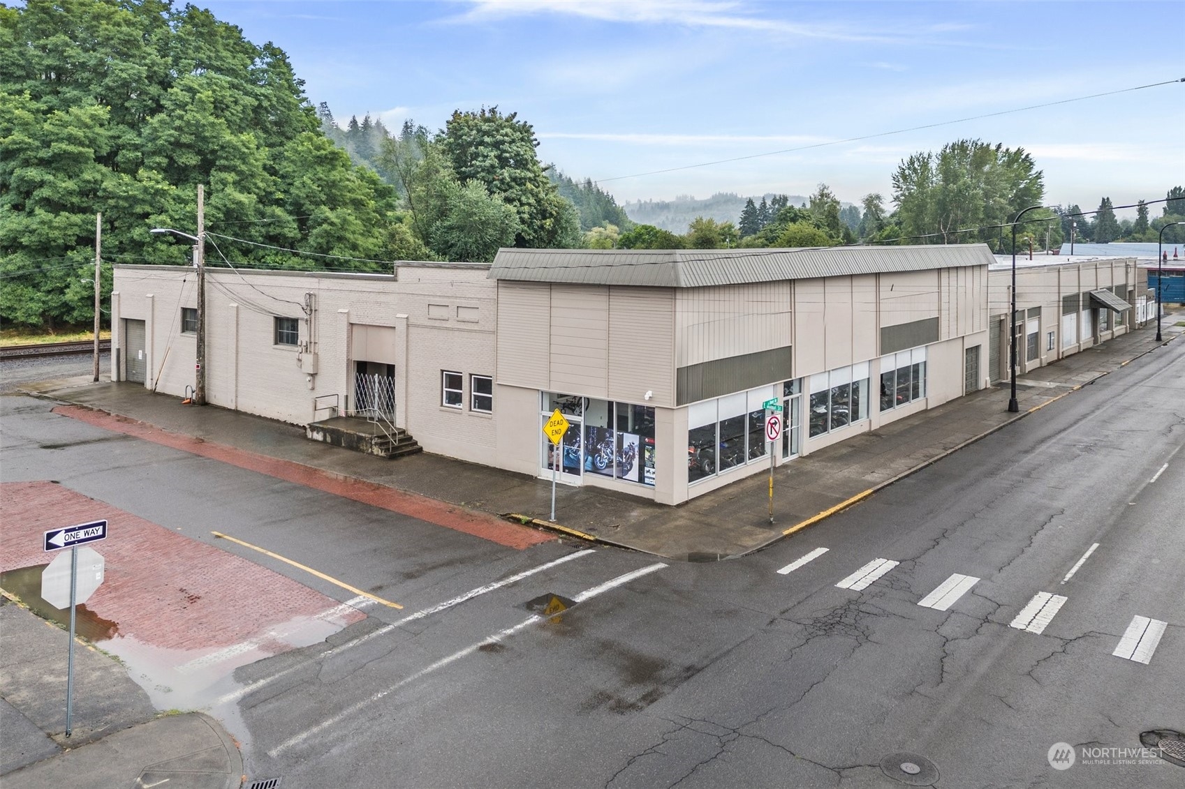 With street frontage on 2 sides, this corner building has 12,000 square feet of commercial/Retail/Office space with 3,000 square feet of bonus storage on the second floor. Easy access with a loading dock on the north end of the building and a loading ramp into the NE corner of the building. Previous business was here for over 28 years. Building could be used as retail space, divided into office space, possible warehouse space or any combination.  Rents are all Pro-Forma based on NNN.