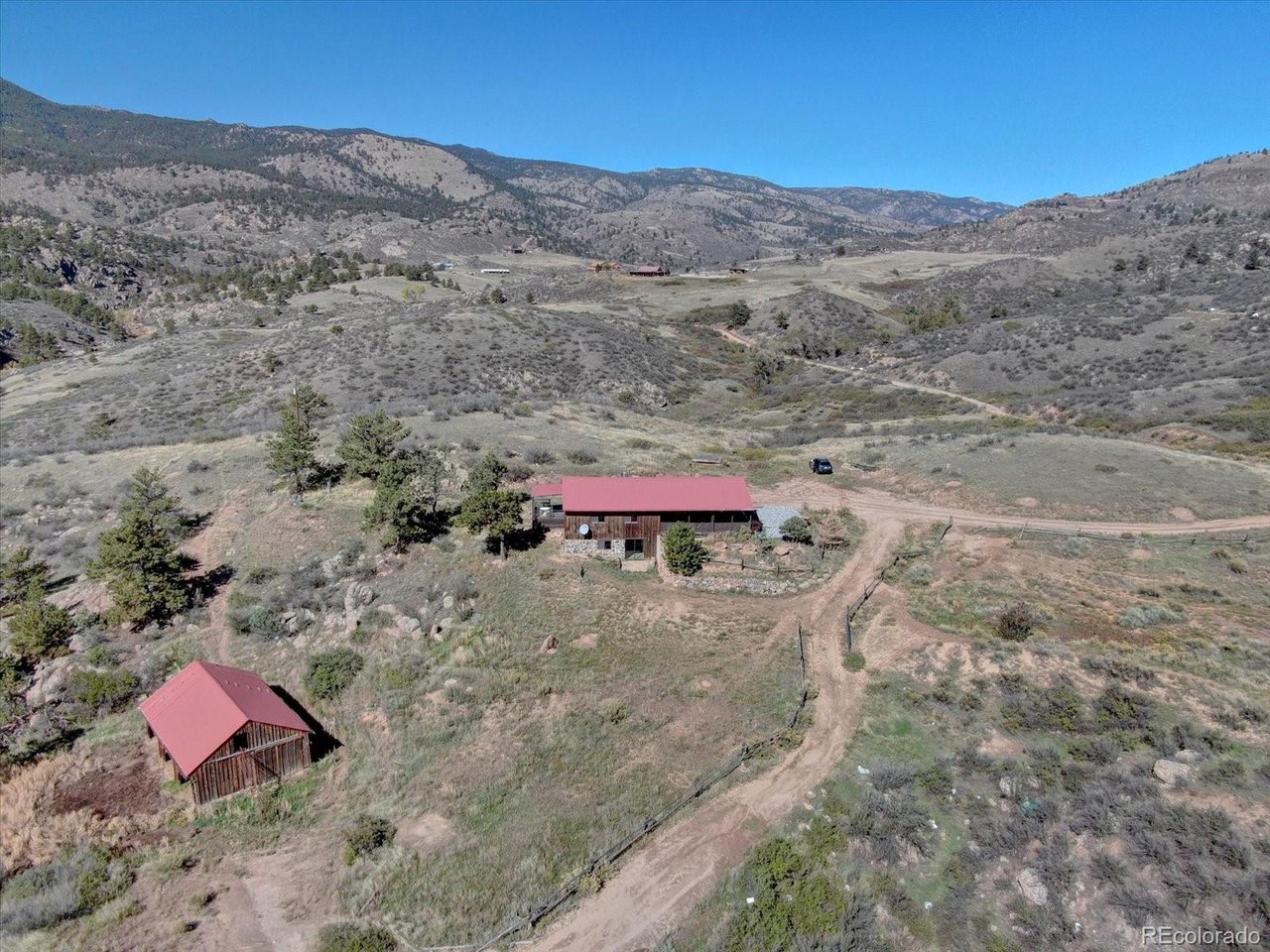 Luxury Live Auction! Bidding to start from $1,000,000.00! Rare 80-Acre Mountain Ranch Estate on the Little Thompson River. Discover your private sanctuary on this extraordinary property just minutes from Boulder. This updated 3-bedroom, 2-bathroom single-level home offers an authentic CO ranch lifestyle with breathtaking pano views up and down the valley. An open floor plan features a wood burning stove, renovated kitchen , island, quartz tops, and stainless appliances. Luxury vinyl flooring and fresh modern paint flow throughout. The primary suite includes an three-quarter bath and direct deck access to stunning mtn vistas. Two guest bedrooms share a full bath. The walk-out basement offers an opportunity to add square footage to your desires. Exceptional Investment & Development Opportunity. This property grants remarkable flexibility for the visionary buyer. Build your custom dream home on the pristine 40 acres along the Little Thompson River while keeping the existing beautifully updated home as a lucrative investment property. Alternatively, consider selling the existing home with 40 acres and create your ultimate riverside estate on the adjoining riverfront acreage. The possibilities for wealth building and legacy creation are extraordinary. This exceptional property is accessed thru a private gate and features a wrap-around covered deck that brings the panoramic views into your everyday life. Horse enthusiasts will appreciate the three-stall barn and ample acreage for equestrian pursuits. With 80 acres of pristine Colorado land, the possibilities are endless-whether you're seeking a working ranch, recreational paradise, or peaceful estate. Nestled in the desirable Lyons area, you'll enjoy mountain tranquility while remaining accessible to town amenities and the vibrant Front Range community. Once in a lifetime opportunity to own a turn-key mtn property with river frontage, horse facilities, investment potential, and 360 degree breath taking views. WOW!
