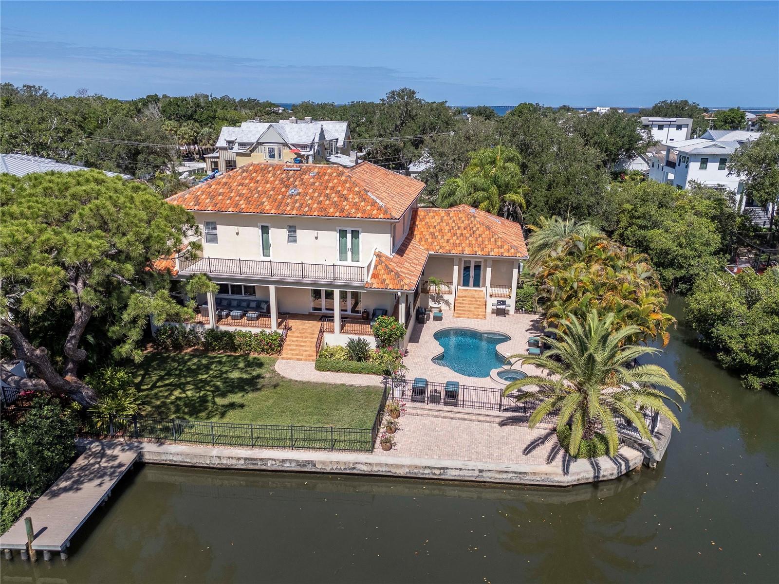 Virtually Staged. RARE WATERFRONT OPPORTUNITY in the highly sought-after A rated Mabry/Coleman/Plant School District in South Tampa! Situated on a large 13,938 SF corner lot with approx 236' of canal and lagoon frontage, this exceptional Tampa home offers the ultimate blend of luxury, space, and coastal living. This all-block 4-bed/4-bath home features 10' ceilings, rich wood flooring, and a bright, open-concept floor plan designed for modern living and entertaining. The 1st level primary suite is a true sanctuary overlooking the lagoon. The chef’s kitchen is equipped with high-end appliances, granite countertops, and a large eat-in breakfast area, making it ideal for gatherings and everyday living. Upstairs, you’ll find 3 beds/2 bath and a flex/bonus room. Additional highlights include: Resort-style pool & spa, lanai, dock with quick access to the bay, and a huge back yard. Experience true Florida waterfront living—boating, entertaining, and manatees frolicking right from your backyard! Schedule your private showing today.
