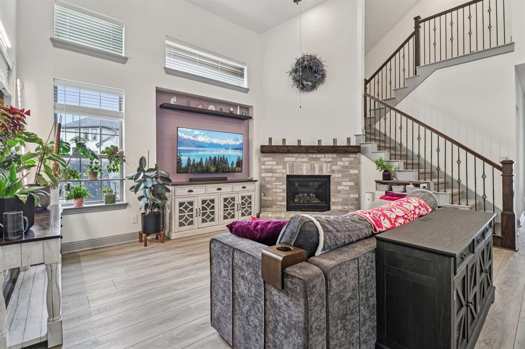 West-facing and beautifully maintained, this upgraded corner-lot home in Arlington’s highly sought-after Viridian community offers standout curb appeal with custom flower beds, lush landscaping, and a welcoming front patio.Inside, the flexible layout features luxury vinyl plank flooring, custom tile work, upgraded lighting, ceiling fans, and full surround sound throughout the home. You’ll also find **two versatile flex spaces—one on each floor—**perfect for a study, media room, game room, or additional living area. The gourmet kitchen is a showstopper with extended quartz countertops, custom cabinetry for added storage, a large island, built-in gas cooktop, electric oven, microwave, three-drawer dishwasher, and a walk-in pantry, all overlooking the living room’s inviting gas fireplace. Step outside to your private backyard retreat featuring a pergola, concrete BBQ pad, chimenea, glass-enclosed patio, and a temperature-controlled swim spa surrounded by lush privacy landscaping and solar fountains. Additional highlights include solar panels, security system, automated exterior and roofline lighting, and a finished 2.5-car garage with epoxy floors and Elfa shelving. Located in the award-winning Viridian community, residents enjoy lakes, a sailing center, miles of walking and biking trails, parks, pickleball and tennis courts, and saltwater pools—just minutes from shopping, dining, major highways, and about 10 minutes from AT&T Stadium, Globe Life Field, and Texas Live!