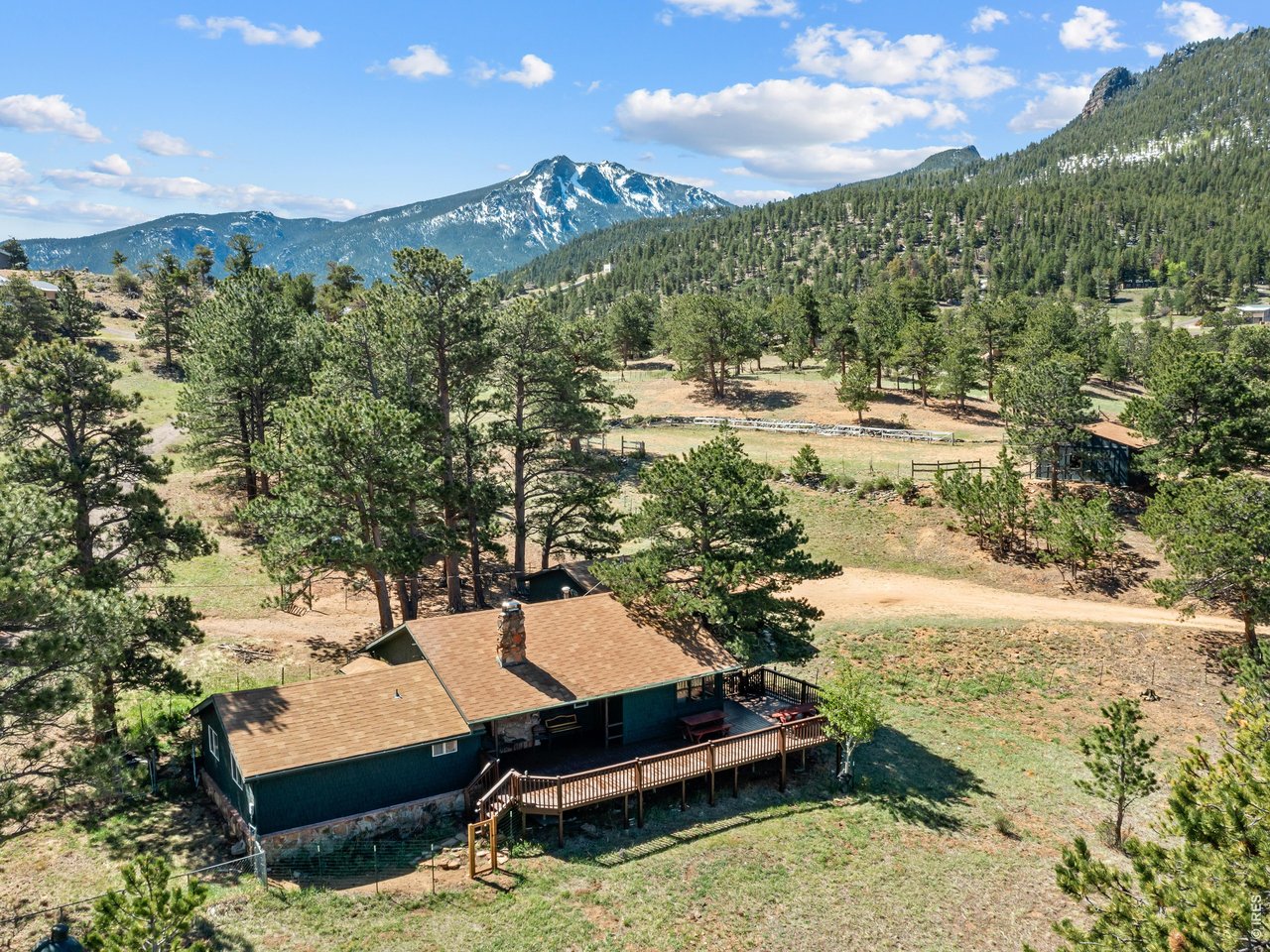 Wow! What a deal for this one! Peace and quiet await on this special 2.75-acre horse property near Marys Lake and just minutes from Rocky Mountain National Park. A classic knotty-pine interior welcomes you into this comfortable 3-bedroom, single-level home, offering inviting spaces for everyday living as well as gathering with family and friends.The expansive deck is the perfect place to spend a quiet afternoon, take in the snow-capped mountain views, or entertain guests. Inside, original knotty-pine walls and beams, along with a native-stone fireplace, create a warm and inviting great room with true mountain character.The property is well equipped for your animal friends, featuring a detached 2-bay garage with shop space, a barn/loafing shed with power and water, and a fenced dog yard. The land itself is full of character, with mature trees and expansive mountain views in every direction. Ideally located just 5 minutes from Rocky Mountain National Park and downtown Estes Park, this is a rare opportunity to enjoy space, privacy, mountain views, and convenience all in one special property. Ideal space to build your dream home and convert the cottage to a guest house. Priced to sell at $639,000, come take a look and experience it for yourself!