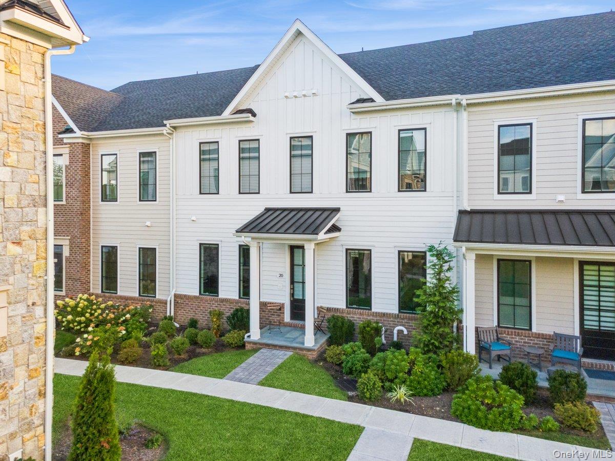 Welcome to 20 Wallace Way – a rare offering in the sold-out Chappaqua Crossings Carriages community. This sophisticated Byram Wetherby model redefines townhouse living with nearly 3,000 sq. ft. of thoughtfully curated interiors, exceptional finishes, and inviting outdoor spaces. Ideally set along an expansive open lawn, the home enjoys abundant sunlight, privacy, and serene views throughout the day.

The main level is designed for both everyday living and entertaining, featuring a dramatic great room with fireplace and seamless connection to the chef’s kitchen. A striking oversized island anchors the space, complemented by custom cabinetry, premium appliances, and an elegant dining room with adjacent butler’s pantry. A bright home office/library adds versatility, while a stylish mudroom with built-ins leads to the two-car garage with electric charger and ample storage. Upstairs, the primary suite serves as a serene retreat, complete with a spa-inspired bath and a spacious walk-in closet. A well-appointed secondary bedroom and bath offer comfort for family or guests. Enhancing the level even further is an oversized sunlit loft, complete with a wet bar, that flows seamlessly to a private rooftop terrace—an ideal setting for both quiet evenings and lively gatherings.

Life at Chappaqua Crossings Carriages extends well beyond the front door. Residents enjoy walkable access to the pool, clubhouse, and fitness center, as well as nearby Whole Foods, Life Time, shops, and restaurants. A dedicated shuttle to the train offers effortless Manhattan commutes, while golf courses, parks, and the best of the Hudson Valley are just minutes away.
Built by Toll Brothers, celebrated for their quality and craftsmanship, 20 Wallace Way seamlessly blends modern design, luxury amenities, and the charm of a vibrant community.