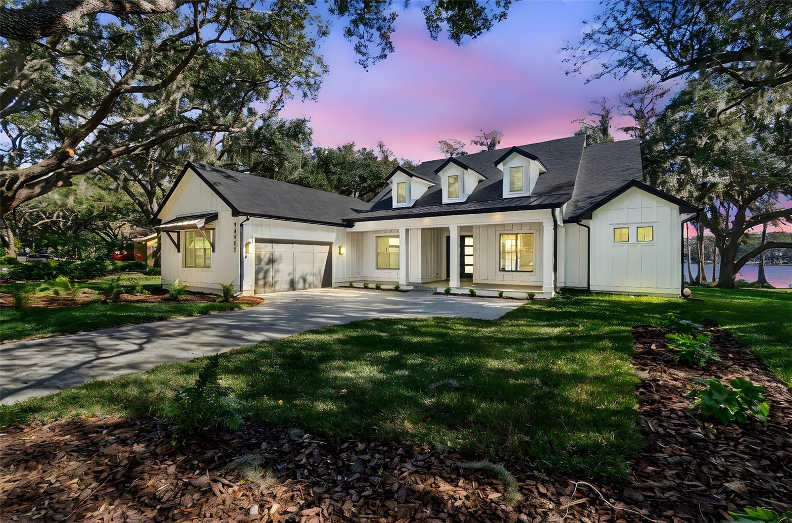 Under Construction. Welcome to one of Odessa’s rare treasures—a brand-new Arthur Rutenberg custom home, thoughtfully built by a private owner on their own half-acre homesite along the sparkling, 100-acre ski-size Lake Ann. This is not a builder-held or speculative home, but a carefully planned custom residence set within a park-like setting shaded by majestic grandfather oaks, surrounded by quiet rural beauty and luxury lakefront estates. The lake itself is private, with no public access, offering a serene and exclusive waterfront lifestyle that feels worlds away from the city, yet remains close to everything you need. With no HOA or CDD fees, you enjoy the freedom to live on your terms.Designed to frame the lake like a piece of art, the great room opens through 10-foot PGT pocket sliders that disappear into the wall, creating a seamless blend of indoor comfort and outdoor living. Morning coffee takes on new meaning when the primary suite shares uninterrupted water views, while 10- and 12-foot recessed ceilings, architectural beams, and refined finishes elevate the home’s overall feel.Every detail was carefully considered, from PGT impact windows and hurricane-rated garage doors to a whole-house water conditioning and softening system. The kitchen delivers both beauty and function with 42” cabinetry, a hidden walk-in pantry, and GE Monogram appliances, while future-ready features include generator wiring, power for a dock and outdoor kitchen, additional floor outlets, and a mini-split A/C in the garage.Outdoor living continues to impress with tongue-and-groove ceilings on the front porch and lanai and a smart low-voltage connectivity package already in place. With an anticipated completion date of January 26, 2026, this exceptional lakefront residence offers a rare opportunity to begin the next chapter surrounded by natural beauty and Odessa’s quiet, timeless charm.A truly rare offering of luxury new construction on a private ski lake—without HOA or CDD restrictions.