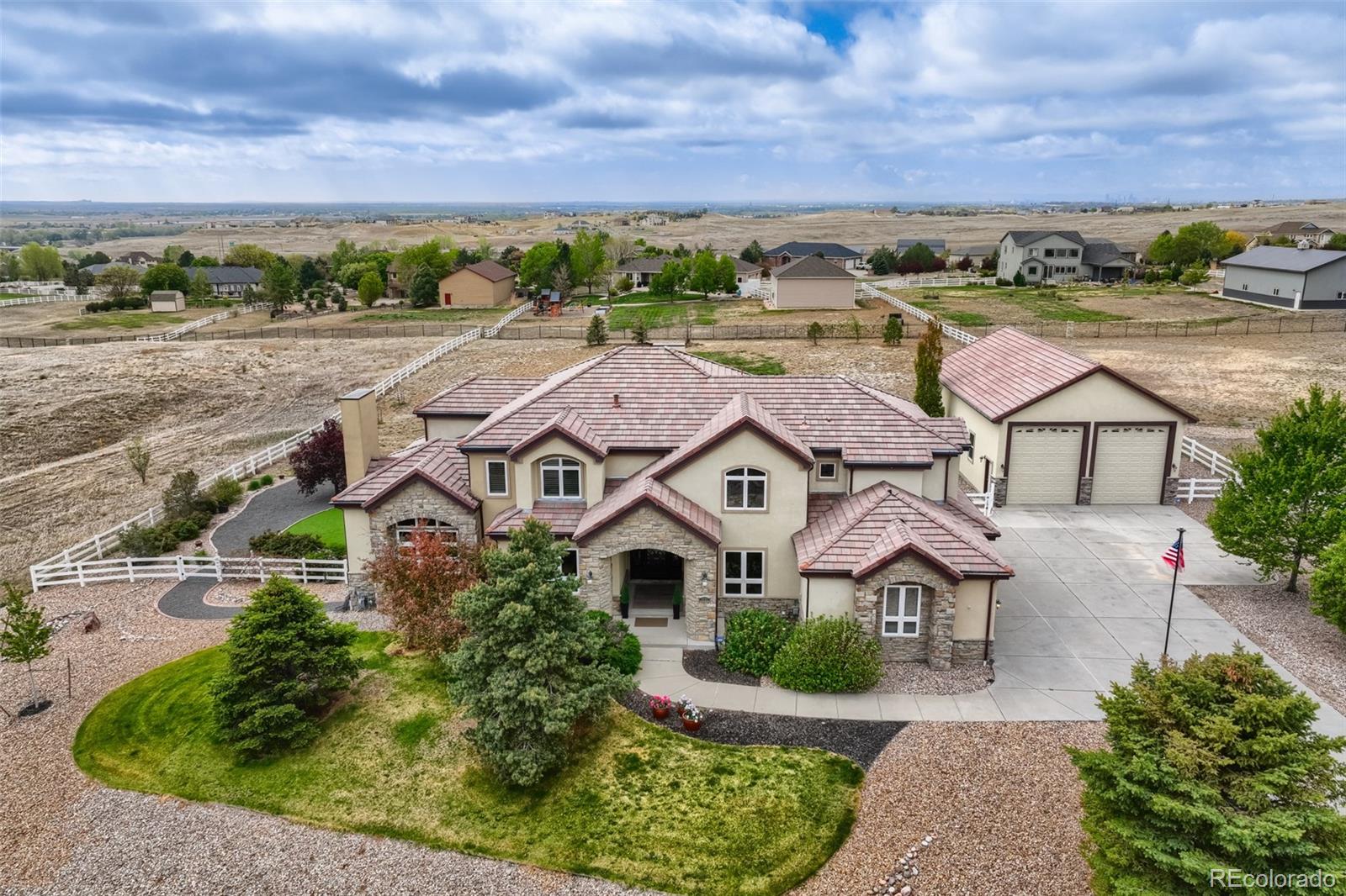 Welcome to this beautifully maintained two-story home in one of the area’s most sought-after gated communities, Todd Creek Estates. Situated on 1.67 acres, this exceptional property seamlessly blends luxury, functionality, and the very best of Colorado outdoor living. From the moment you arrive, the curb appeal is undeniable, setting the tone for the impressive design and spacious feel of the home. Step inside to a dramatic, soaring two-story grand entryway that opens to a formal living area, perfect for welcoming guests or relaxing in style. Just off the grand entry, the main-floor executive study provides a quiet, refined workspace. Upstairs, a second executive study overlooks the impressive entry below, offering a striking and inspiring setting for today’s work-from-home executive. The chef’s kitchen is a true centerpiece, featuring a generous island, abundant cabinetry, coffee bar, butler panty and top-of-the-line appliances. Enjoy direct access to the expansive covered patio, perfect for entertaining or taking in the peaceful outdoor views. The adjoining great room is ideal for both everyday living and entertaining, complete with a cozy fireplace that adds warmth and character. Upstairs, the luxurious primary suite features a spa-inspired 5-piece bathroom with a walk-in shower and an expensive walk-in closet. Bring all your toys!!! The standout feature of this property is the massive custom shop, perfect for hobbyists, car enthusiasts, or animal lovers. This fully finished building includes heat, air conditioning, extensive lighting, and durable concrete floors, with ample space for RVs, boats, and all your recreational vehicles. Truly all the features you look for in an amazing shop. Downstairs, the finished walkout basement is an entertainer’s dream, complete with kitchenette/wet bar, a luxurious bathroom, and a bedroom with fireplace. This versatile space is ready for a home theater, game area, gym or additional custom features to suit your lifestyle.