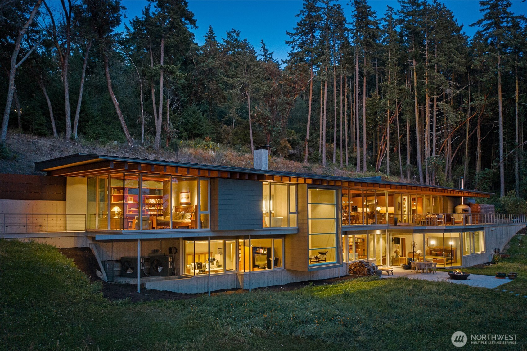 Set along the coveted west side of San Juan Island, this extraordinary waterfront estate is a striking expression of contemporary architecture by the renowned firm Bohlin Cywinski Jackson. Privately positioned on 6 sunlit acres in 4 tax parcels with 400 feet of pristine shoreline, the residence offers nearly 6,500 square feet of thoughtfully designed living space where modern design meets the island's natural beauty.    Dramatic volumes, floor-to-ceilings glass, and warm natural materials create an atmosphere of understated luxury while framing breathtaking views of Haro Strait and the Olympic Mountains. The main level is anchored by a chef's kitchen, sophisticated great room, and a serene primary suite designed for quiet retreat. The lower level offers inviting guest accommodations, a wine cellar, and flexible hobby or studio space.    Completing the estate are a substantial workshop and garage, a fully equipped greenhouse, and fenced gardens — ideal for those seeking both beauty and self-sufficiency. Watch whales pass through Haro Strait, enjoy spectacular sunsets, and experience the rare privacy and tranquility that define San Juan Island's most sought-after west side living.