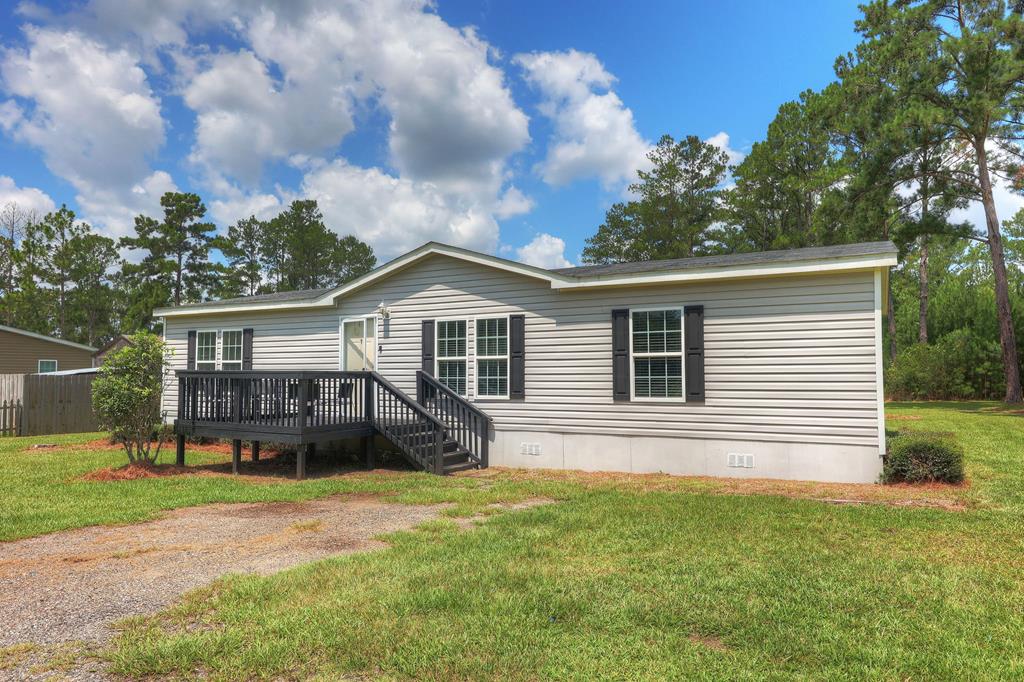 Escape to the peace and quiet of country living in this beautifully maintained 2017 manufactured home, perfectly situated on nearly an acre of land. Filled with natural light, the open and airy floor plan creates a warm, inviting atmosphere that's ideal for both everyday living and entertaining.  The spacious kitchen offers abundant cabinet and countertop space, a center island for meal preparation and gathering, and a layout that flows seamlessly into the living and dining areas. Recessed lighting throughout the home adds a modern touch and enhances the bright, welcoming interior.  The private owner's suite is a true retreat, featuring a generous ensuite bath complete with a relaxing garden tub, separate shower, and ample space to unwind after a long day. Additional bedrooms provide flexibility for family, guests, or a home office.  Enjoy your morning coffee on the front deck or host weekend cookouts on the rear deck while taking in the peaceful country surroundings. With nearly an acre of land, there's plenty of room for gardening, outdoor recreation, or simply enjoying the open space.  If you're looking for a move-in-ready home that combines modern comfort with the tranquility of country living, this well-cared-for property is one you won't want to miss.