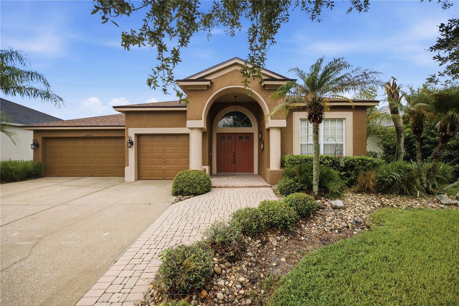 Live the Florida lifestyle you’ve been looking for in Lexington Oaks! Perfectly positioned along the golf course and overlooking tranquil water views, this 4-bedroom, 2-bath home offers the space, setting, and potential to create your own personal retreat in one of the area's most amenity-rich communities. From the moment you arrive, the home welcomes you with French doors opening to a spacious foyer, formal living and dining areas, and a versatile split-bedroom floor plan. The heart of the home features an expansive kitchen with a center island, breakfast bar, large pantry, and stainless steel appliances, all flowing into a generous family room with picture windows and sliding glass doors that showcase the beautiful outdoor surroundings. The primary suite offers a private escape with backyard access and an en-suite bath featuring dual sinks, a garden tub, and a separate walk-in shower. Step outside to the oversized screened lanai and imagine starting your mornings with peaceful POND and GOLF COURSE VIEWS or ending your day enjoying Florida sunsets—with no rear neighbors to interrupt the scenery. But life here extends far beyond your backyard. Lexington Oaks is truly a lifestyle community, centered on an 18-hole championship golf course that offers convenient pay-as-you-go play. Residents can also enjoy playgrounds, a splash pad, community center, fitness facilities, tennis and pickleball courts, a soccer field, basketball courts, and more. Grab a bite at Omari’s Bar & Grill, enjoy the convenience of two daycare facilities at the community entrance, or explore the growing Hub, featuring restaurants, shopping, and a golf simulator. With easy access to I-75 and I-275, hospitals, schools, shopping, dining, and the Tampa Premium Outlets, you’ll enjoy the perfect combination of recreation, convenience, and connectivity. With an exceptional setting, generous living spaces, breathtaking golf course and pond views, and the opportunity to make it your own, this home is your chance to enjoy everything the Lexington Oaks lifestyle has to offer.