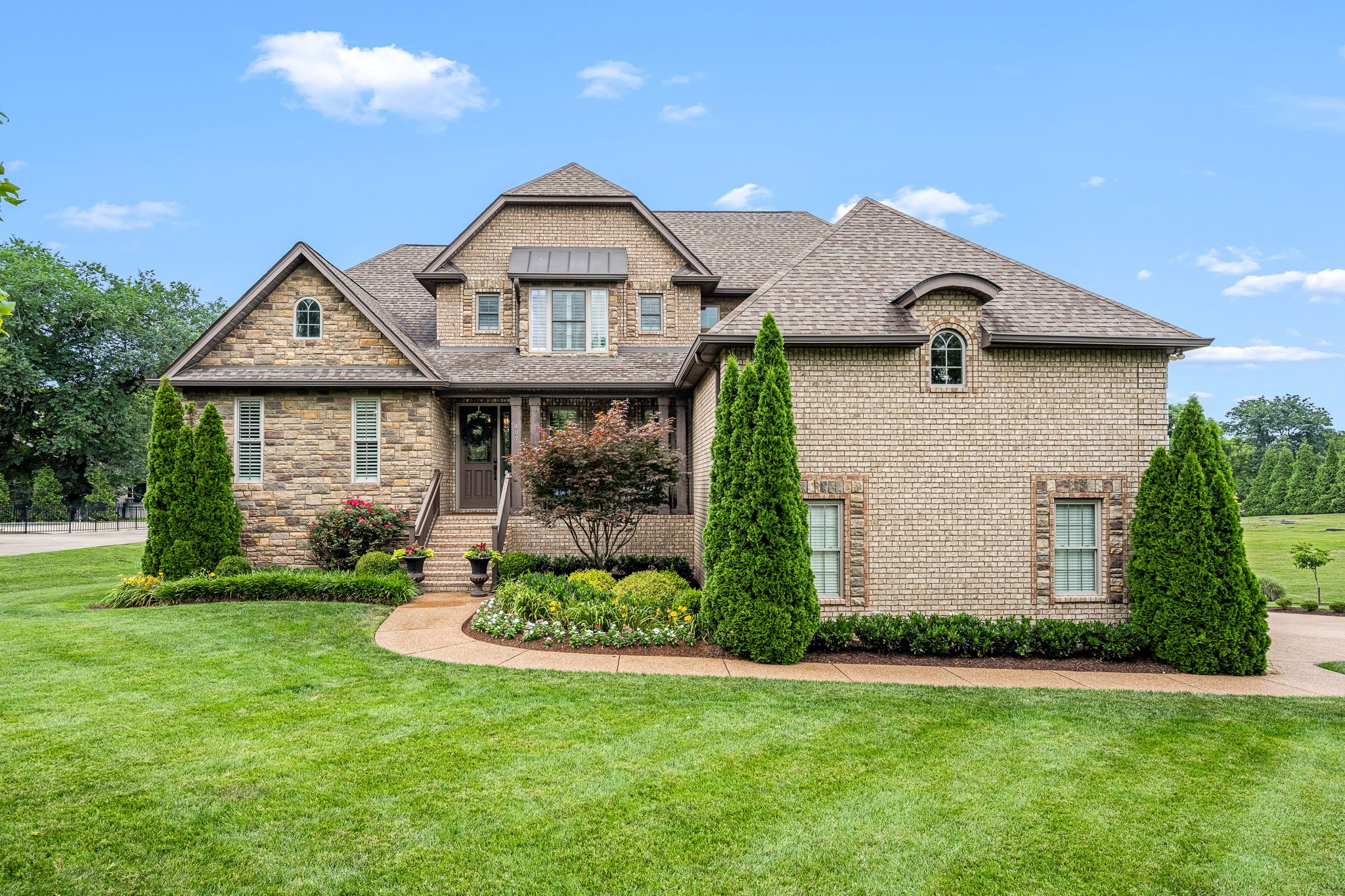 A real gem on Old Hickory Lake w your private marina for your boat and jet skis! (32x12 boat slip w new lift and 2 jet ski slips) Nestled in a private cul-de-sac, this beautifully updated 5936 sf property with 5 BRs, 4 full BA plus 2 half baths (including in-law suite w kitchen!) on over 1/2 ac is designed for day-to-day livability and a layout out for entertaining. Recently updated kitchen w new oversized quartz countertop island (hidden cabinets underneath for storage), high-end stainless appliances (6 burner gas cooktop, double ovens, micro, warming oven, refrig and adjoining walk-in pantry. Exquisite tall coffered/trey ceilings throughout main level and hardwood floors. Expansive open plan on main level w large screened porch to extend your entertaining area. MBA renovated with new tile, tub, shower, counter tops. His/hers custom closets. Upstairs-3 Br, playroom (wet bar), Large office. Your guests will enjoy the in-law suite on lower level with kitchen and their morning coffee on adjoining covered porch w swing. New whole house generator. Wine cellar. Work out room/safe room. 4 Car Garage great to winter your boat! 15 min to BNA and 20 min to downtown Nashville. Golfing nearby at Old Hickory CC and Hermitage CC. Extensive amenities on listing attachment. Enjoy the good life in this exquisite home!