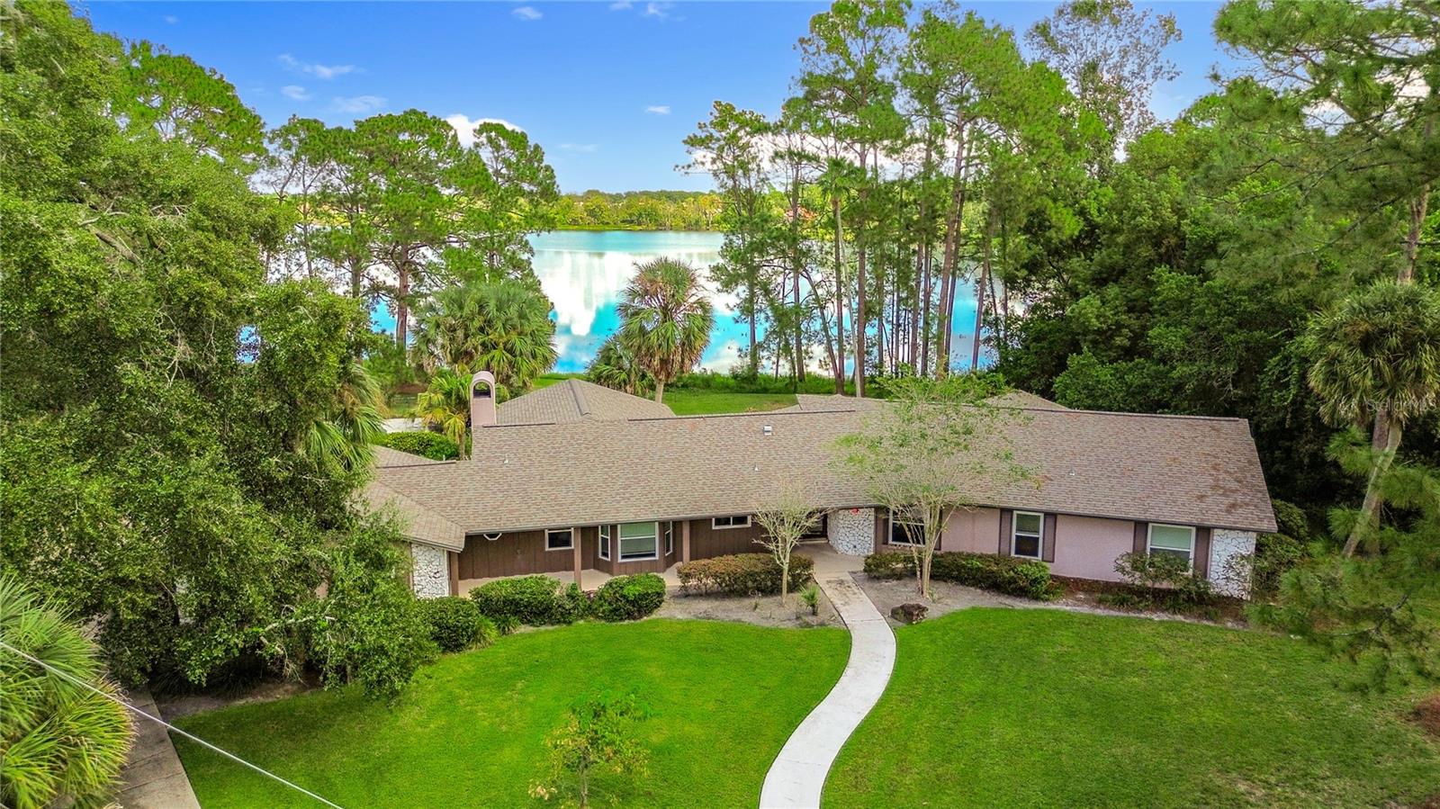 Under contract-accepting backup offers. Under contract-accepting backup offers. MULTIPLE OFFERS highest and best due by 10-06-2025. Welcome to 3 Village Green, a rare waterfront estate situated on over 2 acres in the heart of Longwood. This 4-bedroom, 3-bath, 3,247 sq. ft. residence features a spacious and flexible floorplan with a grand family room, fireplace, and tranquil lake views. The property showcases mature trees and natural surroundings with plenty of space to design an outdoor retreat with a pool, gardens, or patio. While move-in ready, the home also offers an excellent opportunity for updates and personalization to enhance its value. The location provides both privacy and convenience with nearby shopping, dining, top-rated schools, and easy access to SR 434, Lake Mary, and Orlando. Properties combining land, water frontage, and this level of potential are a rare opportunity in Seminole County.