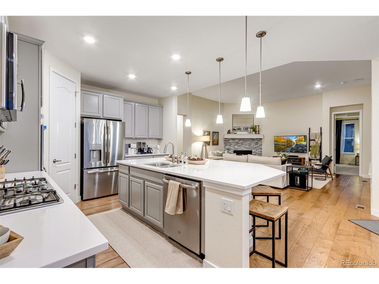 Experience refined Colorado living in this beautifully designed modern ranch backing to community open space with peaceful north-facing views. Enjoy cool summer evenings on the covered back deck overlooking the open space, offering privacy and a true indoor-outdoor lifestyle.This sprawling 5,099 total sq ft home features 100% main-floor living with 4 bedrooms and 3 bathrooms in a thoughtful split floor plan. High ceilings, 8' doors, wood flooring, and a bright open layout create a clean, modern aesthetic highlighted by white quartz countertops throughout.The chef's kitchen is built for both function and entertaining, offering stainless steel appliances including double ovens, a large quartz island, walk-in pantry, and seamless flow into the living room with a gas fireplace. A formal dining room provides space for gatherings and special occasions.The spacious primary suite captures open space views and includes a large walk-in closet and an oversized shower with poured pan for a luxurious retreat experience. An unfinished basement provides significant future expansion potential or abundant storage. The 3-car garage and solar panel system enhance both convenience and energy efficiency. Located in highly desirable Wildwing community featuring four neighborhood parks, walking and bike paths, an outdoor pool, and access to Timnath Reservoir. This home delivers lifestyle, space, and long-term value in one exceptional package!