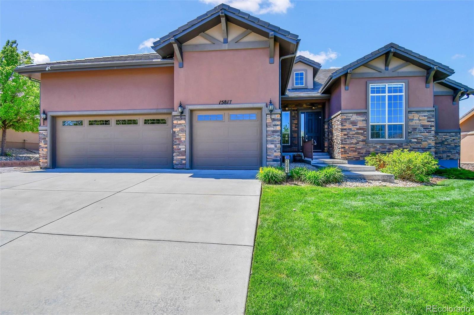 Highly sought-after Anthem Ranch Antero model offering over 4,700 finished square feet of thoughtfully designed living space, enhanced by approximately $200,000 in builder upgrades and a professionally finished $150,000 basement. A full 4-foot structural extension expands the main living area, with an additional 4-foot garage extension providing exceptional interior flow and storage.Extended hardwood floors span the office, family room, kitchen, living room, and hallways. A light-filled office with tall ceilings and dual glass French doors sits beside a stylish half bath and double-door coat closet. The formal dining room features a granite buffet with glass upper cabinets. The spacious family room showcases a custom fireplace mantle and opens to a gourmet kitchen with granite countertops, two-tone island, white and espresso cabinetry, white backsplash, KitchenAid gas cooktop with hood, and a four-door refrigerator. Pendant lighting and upgraded window coverings complete the space.Enjoy outdoor living on the covered deck surrounded by mature landscaping, stamped concrete walkway, and subtle mountain views. The primary suite offers a tray ceiling with crown molding, seven large windows, and a luxurious bath with marble dual sinks, soaking tub, and full-height tiled shower with glass enclosure. The walk-in closet includes custom organizers and tile flooring. A private guest suite features a walk-in closet and en-suite bath with quartz counters and designer tile.Additional main-level highlights include a large laundry room with Samsung washer and dryer on pedestals, utility sink, cabinetry, and space for a second refrigerator, plus a mudroom with built-ins. The finished basement boasts 10-foot ceilings, structural steel floor system, kitchenette, expansive living areas, third bedroom, upgraded bath, and abundant storage including crawl space. Resort-style amenities complete the offering.