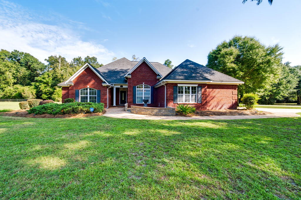 FOUR-BEDROOM POOL HOME | COUNTRY CLUB ESTATES | BAINBRIDGE, GEORGIA Located directly across from Bainbridge Country Club, this spacious 4-bedroom, 3-bath brick home sits on a 1.12-acre corner lot in desirable Country Club Estates. Offering a thoughtful blend of comfort, privacy, and versatility, the home features an inviting open-concept kitchen, dining, and living area designed for both everyday living and entertaining. A bright breakfast room provides additional casual gathering space, while the sun porch overlooks the expansive backyard and pool.  The split-bedroom floor plan offers exceptional privacy, with two secondary bedrooms sharing a Jack-and-Jill bath on one side of the home. The primary suite and an additional guest bedroom with an adjacent full bath are privately positioned on the opposite side, providing flexibility for guests, a nursery, or home office.  Recent improvements include fresh interior paint and select replacement kitchen appliances. Beautiful hardwood floors extend throughout the main living areas, and the kitchen enjoys a desirable view of the backyard and pool.  Outside, the backyard is designed for relaxation and entertaining, featuring a sparkling in-ground pool surrounded by privacy fencing. A versatile pool house offers additional space for poolside gatherings, an art studio, home office, or flex space. Beyond the pool house, an insulated workshop wired w/ power provides valuable space for hobbies, storage, or other projects.  Located directly across from Bainbridge Country Club, with access to golf and pickleball, and just minutes from downtown Bainbridge, shopping, restaurants, and the Flint River, this property offers generous space, flexibility, and an exceptional location for enjoying the best of Bainbridge living. (some photos w/ furniture have been virtually enhanced)
