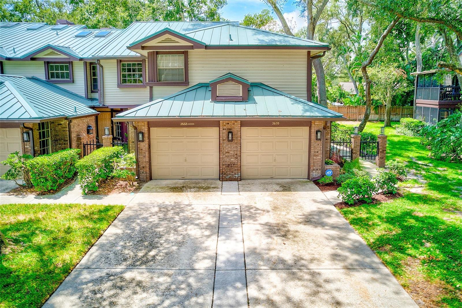 Welcome to Laurel Oaks, a picturesque, tree-lined community just steps from the Pinellas Trail and the Dunedin Causeway, where waterfront sunsets, live music, and local dining are part of everyday life. This tastefully updated 2-bedroom, 2-bath condo offers the perfect blend of style, comfort, and convenience. Step inside through your private first-floor entrance and discover a spacious open floor plan with soaring vaulted ceilings, fans, and skylights that fill the home with natural light. The living and family rooms are centered around a cozy wood-burning fireplace and open seamlessly to a screened balcony, recently updated with new screens and railings, perfect for enjoying morning coffee or evening breezes. The kitchen is a tastefully updated, featuring granite countertops, stainless steel appliances, tile backsplash, double-door pantry, track lighting, and cabinet pull-out drawers for easy storage. Beautiful wood floors flow throughout, including the stairway, giving the home warmth and character. Retreat to the expanded primary suite with a walk-in closet and a spa-like bathroom boasting a gorgeous tiled shower and updated flooring. The second bathroom has also been tastefully refreshed. Laundry is conveniently located inside the unit. Additional updates include a Ring doorbell, security system, and new community metal roofs with skylights installed in 2024. Your private under-building one car garage, with an additional tandem driveway makes parking a breeze. Laurel Oaks is a very pet-friendly community, making it a wonderful place to call home. With its unbeatable location and stylish upgrades, this condo delivers exceptional value. Fall in love with your new home, schedule your private showing today!