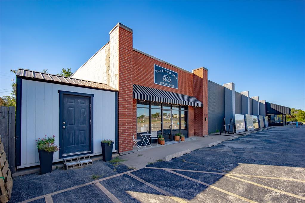 1,990 SF retail and production space on N Porter Avenue in Norman, available December 1. Street-facing showroom with wide storefront glass and parking at the entry. Behind it: two workspaces, one with a stainless prep sink and open floor for work tables, two walk-in coolers, a utility room, a restroom, and an enclosed room for an office or consultation space. Suited to florists, bakeries, specialty food, catering, and boutique retail. $12.00/SF/Yr
