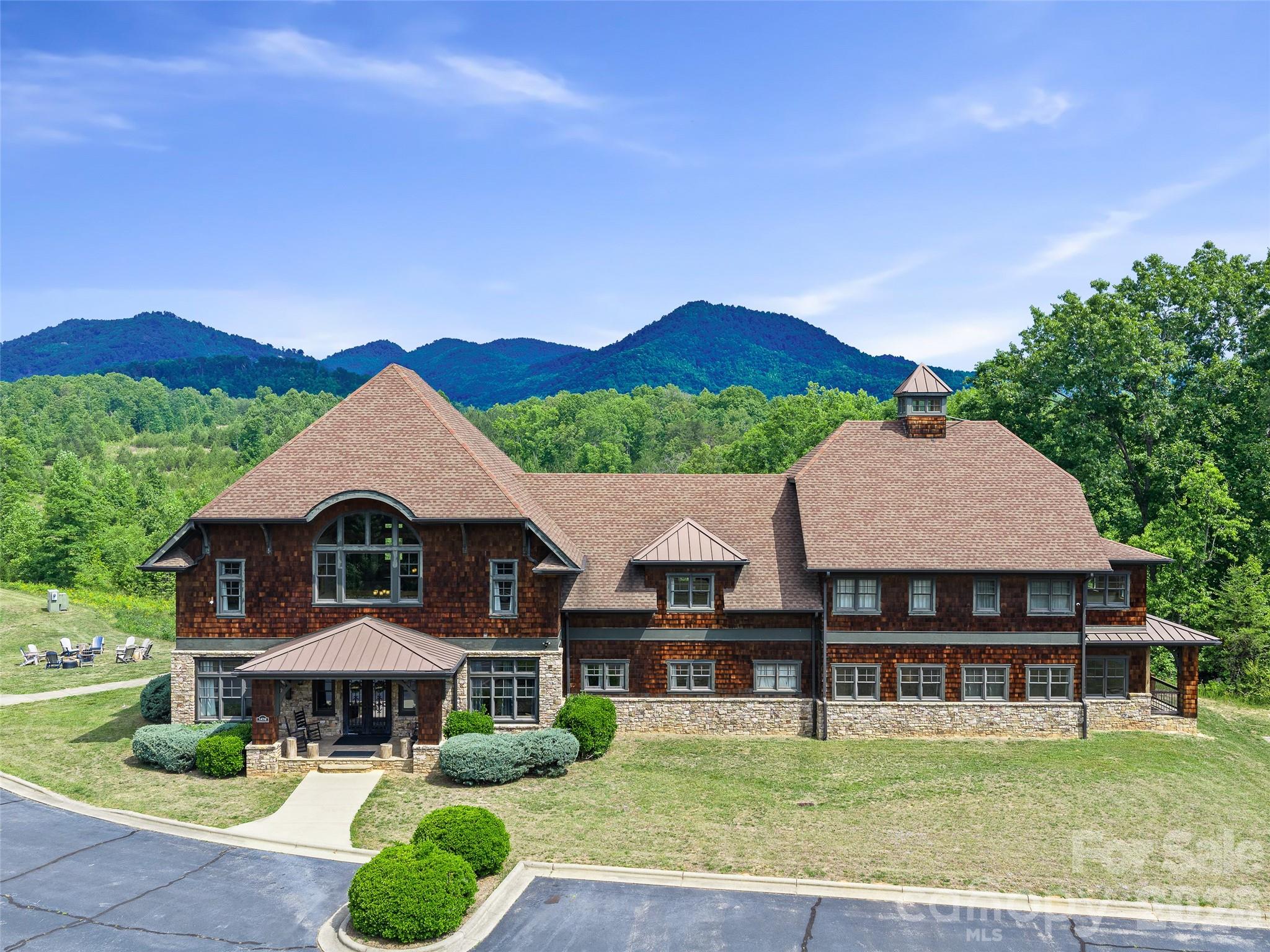 Once-in-a-Lifetime Estate in Union Mills!This extraordinary property offers unlimited possibilities with 65 gently rolling acres, an 8,950 sq. ft. lodge, a one-bedroom Gate House, and 6 brand-new log cabin rentals, plus additional development opportunities throughout the property.The lodge is perfectly designed across two levels. The main floor features 4,952 sq. ft. with a massive open great room highlighted by a stunning stone gas fireplace, a sunroom with a hot tub, 4 spacious bedrooms, a TV room, a double kitchen, a bar area, 4 large bathrooms, and a laundry room. The second floor offers 3,998 sq. ft. with 7 large bedrooms, 3 bathrooms, a theater room, a game room, and an additional laundry room.The Gate House is a beautifully finished one-bedroom rental complete with its own private hot tub. The six new log cabins are thoughtfully positioned for privacy, each featuring a covered deck and private hot tub.This property has hosted many weddings and events with a large guest capacity, making it a premier destination for celebrations, retreats, and gatherings. In addition to the existing improvements, there are 8 additional cabin or RV sites ready to go, and the property has a conceptual layout plan showing the potential for up to 88 total RV sites.Whether you’re looking for a luxury private estate, a thriving hospitality business, an RV resort, an equestrian property, a wedding venue, or a family retreat, this property can bring your vision to life.Adding to its uniqueness, the far corner of the property adjoins a Conserving Carolina protected area of approximately 1,500 acres, providing additional privacy and natural beauty. Conveniently located with easy access to I-40, it’s just 24 miles to Tryon International Equestrian Center, 46 miles to Asheville, and 84 miles to Charlotte.This is truly a one-of-a-kind Western North Carolina mountain estate. Schedule your private tour today and experience everything this incredible property has to offer.
