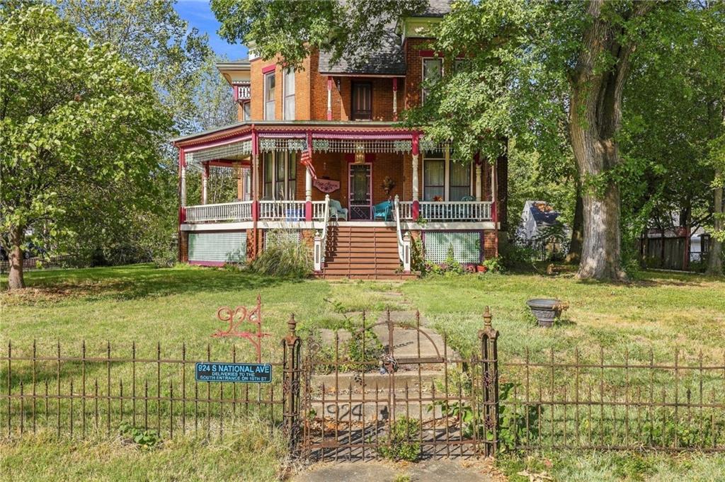 Step into history at this stunning, stately Queen Anne mansion in the heart of historic Fort Scott, KS, where a welcoming hometown atmosphere meets true architectural grandeur. Known to locals as Rose Haven, this impressive home was featured in the film The Learning Tree, written and directed by Fort Scott native and Renaissance Man Gordon Parks. Built in 1882 on four lots as a summer home for a wealthy entrepreneur, it has been meticulously restored and cared for ever since.Across 3,633 square feet, intricate details and unparalleled craftsmanship greet you at every turn: breathtaking hand-carved woodwork, gorgeous original hardwood floors, four fireplaces with ornate original tiles, five sets of solid wood pocket doors, Tiffany stained glass windows, and sparkling crystal chandeliers. Updated electrical, plumbing, roof, and gutters allow you to enjoy the home's history with modern peace of mind.Gather on the wraparound front porch, then explore the library, family room, formal dining room, and eat-in kitchen with granite countertops. The front parlor offers flexibility as a main-level bedroom, and four additional bedrooms are located upstairs.The grounds are just as impressive. A new 3-car garage, added in 2021, includes an upstairs space. The original carriage house still stands alongside a loafing shed and a garden shed, providing room for up to three more cars or plenty of space for hobbies and projects. Set on four lots, there is room to garden, gather, and spread out.Whether you envision a one-of-a-kind private residence, a show-stopping place to host family and friends, or a piece of Kansas history to call your own, homes like this rarely come along. Architectural renderings have even been drawn up to add bathrooms, making it possible to operate a bed and breakfast in this fabulous mansion with a few modifications. With so many legendary stories to tell, you're sure to fall in love with Rose Haven. Schedule your private showing today!
