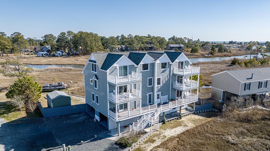 Elegant 3BR, 2.5 bath Waterfront home, 3 covered porches and pier on the Chincoteague Channel. Backside Creek Views, back patio deck, carport, heated storage room This home has undergone high quality renovations, new hurricane shingled roof, New Trane HVAC system, totally renovated kitchen. Upgraded flooring and fully painted interior and carport.  The upgrades are numerous making this home totally like new. 3rd Story Suite with full bathroom and beautiful views. Porches off every level and plenty of parking, Unique property offering for Chincoteague Island.  Duct work professionally cleaned and floor plan available.