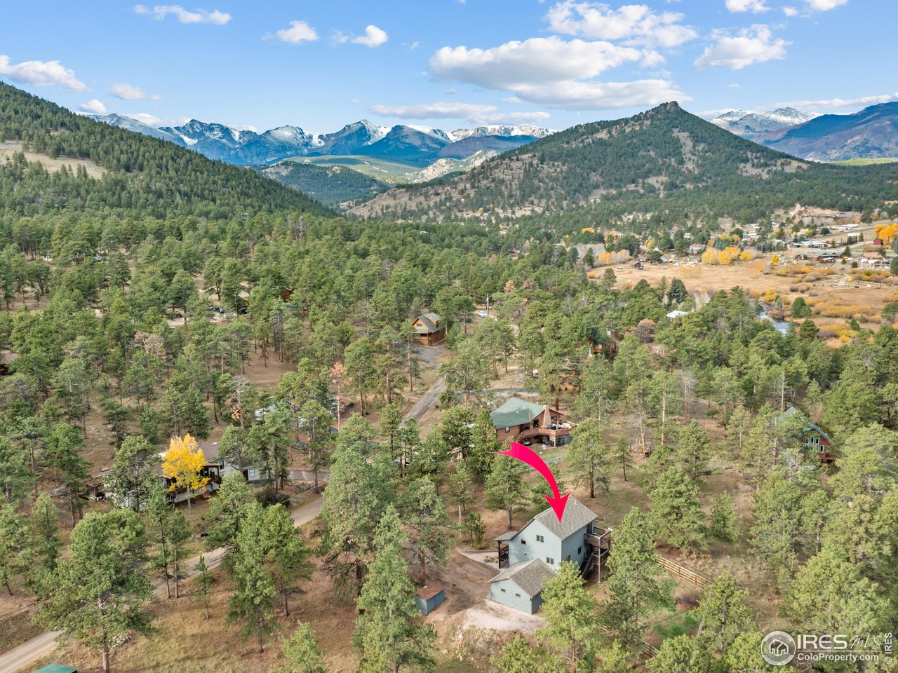 Tucked among the pines on the west side of town, this 3-bedroom, 3-bath home offers the perfect balance of privacy, space, and accessibility to all that the Estes Valley offers. With 2,100 square feet of inviting living space and a generous .84-acre lot, this property gives you room to breathe, play, and enjoy the best of Estes living - just minutes from downtown and the entrance to Rocky Mountain National Park. The home sits proudly among mature trees, with a gently sloping drive leading to a two-car attached garage and covered front porch. It's the kind of home that blends seamlessly into the natural landscape - quiet, established, and thoughtfully cared for. Step inside, and you'll find an open, light-filled layout designed for comfort. Whether you're curled up on the sofa watching a snowstorm roll in or entertaining friends on a summer evening, the space feels cozy yet connected to nature. A sliding glass door opens from the dining room to one of the home's balconies, where you can grill dinner while watching the light shift across the peaks. Upstairs, the primary suite feels like a true escape, with its own private balcony overlooking the mountains. Imagine waking to sunlight streaming through the trees, coffee in hand, and the crisp scent of pine in the air. The lower level adds more versatility - perfect as a recreation room, hobby space, or cozy family den. With walk-out access to the fenced portion of the yard, it's ideal for pets, kids, or simply stepping outside to enjoy the peaceful surroundings. Outdoors, there's plenty of room to garden, play, or just soak in the scenery. This isn't just a place to live - it's a place to thrive, breathe, and reconnect. Welcome home to 1263 Broadview Road - where mountain serenity is part of your every day.