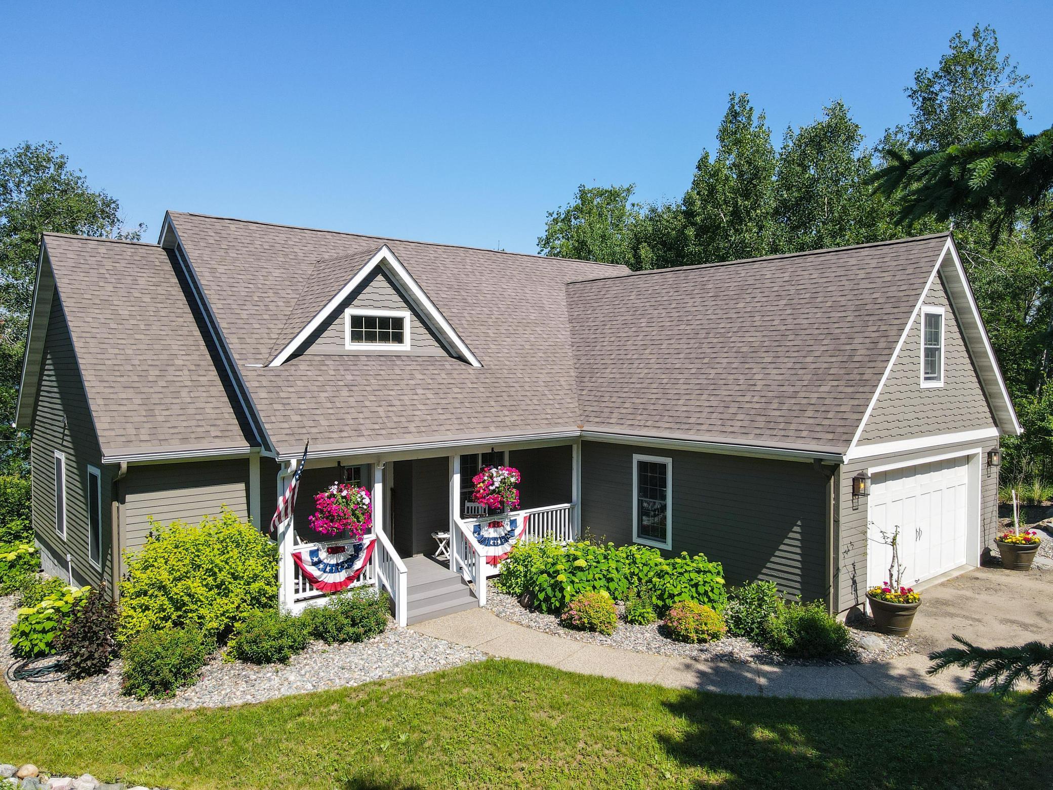 Don't miss an incredible opportunity to own this private lakefront oasis for year-round recreation just six miles from Park Rapids in the heart of Minnesota. Situated in a mature, tree-filled paradise along the peaceful shores of Long Lake, this property offers stunning water and sunset views. Long Lake is a deep, spring-fed lake suitable for year-round water sports and fishing. The home is located on 1.87 acres with about 156 feet of sandy shoreline that is great for swimming. 
Inside the home, you will find a warm, craftsman-style interior featuring 4-bedrooms, 2.5 bathrooms, an open-concept kitchen, dining and living area, and an attached 2-stall garage. A spacious 16' x 20' storage building with finished guest quarters provides a fifth queen sleeping area for guests.  Many of the home's features have been updated since 2020 including siding/trim, gutters, lighting, paint, appliances, countertop, and landscaping. 
When you are outdoors (but not on the lake), enjoy identifying flowers in the North American Prairies wildflower field, growing veggies in the 20’ x 20’ garden enclosure, and hosting events on the three-tier cedar deck and flagstone patio with fire pit.  

Access to the property via Downey Drive has been private since 1947 and still preserves privacy and a tranquil, peaceful setting relished by the 10 residents who enjoy the best of lakeside living today. Don’t miss this rare find!