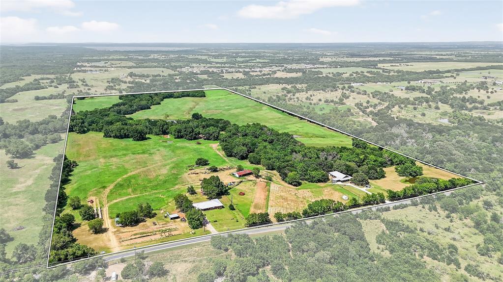 Nestled in a rapidly growing area of Sherman, TX, this stunning 80-acre property on Gage Rd offers the perfect blend of natural beauty, functionality, and future potential. Located in close proximity to the proposed path of the Dallas North Tollway expansion, this land is not only a peaceful rural retreat but also a smart long-term investment with strong development prospects. The property features two well-maintained homes. The first is a 3-bedroom, 2-bathroom, 1,750 sq ft mountain cabin-inspired home with Texas flair, built in 2015. Inside, you'll find an open-concept layout with vaulted ceilings, spacious bedrooms, and a warm, rustic feel. Outside is a 10x20 garage shop and a 20x20 covered carport. The second home is a 3-bedroom, 2-bathroom, 2,113 sq ft ranch-style residence that includes a storm cellar located beneath the attached 2-car garage—ideal for safety and peace of mind. Beyond the homes, the land itself is the real star. With four ponds, including one just over an acre in size, the property is rich in natural water resources. Improved pastures with sandy soil and Coastal Bermuda grass make it ideal for hay production, grazing livestock, or enjoying as a private recreational haven. The ag-exempt status helps keep holding costs low while you enjoy excellent fishing, abundant wildlife, and unmatched privacy. Whether you're looking to build, invest, or simply escape the city, this is a rare opportunity to own a large tract with versatility, beauty, and upside in one of North Texas’s most promising locations.
