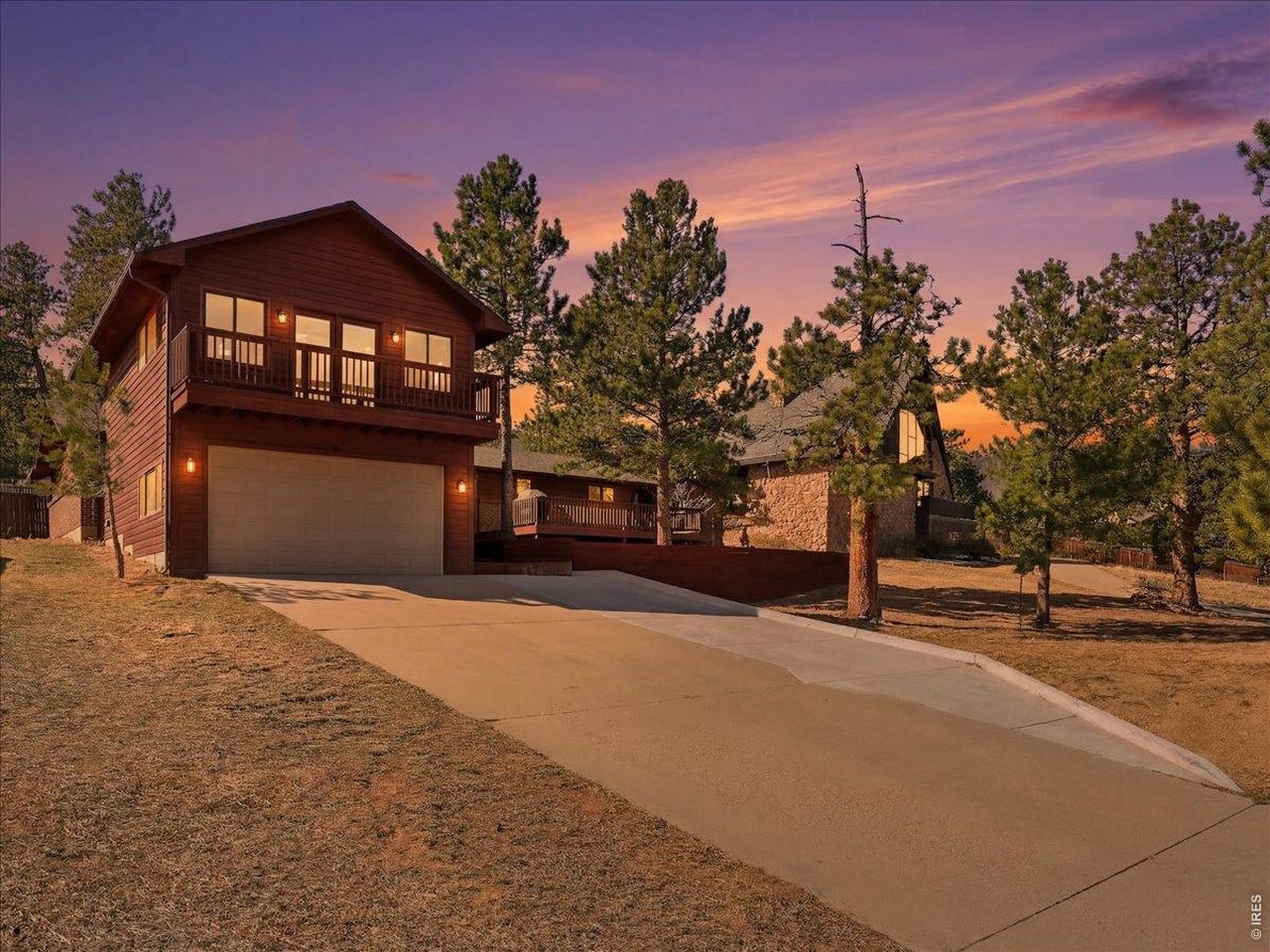 Life in the mountains is easy to enjoy in this 3-bedroom, 3-bath home tucked into the desirable Carriage Hills neighborhood. Thoughtfully designed with comfortable living in mind, this home offers spacious interiors, inviting gathering areas, and peaceful outdoor spaces. The custom remodeled kitchen is both stylish and functional, featuring plenty of workspace, generous counter space, and an easy flow into the surrounding living areas. A separate family room with a wood-burning fireplace creates a cozy place to unwind, while additional living space provides flexibility for entertaining, working from home, or simply spreading out. The spacious primary suite is tucked away for added privacy and includes large windows that capture the surrounding views, a walk-in closet, a private bath, and direct access to its own deck. A covered patio off the kitchen extends the living space outdoors, creating the perfect setting to enjoy morning coffee or quiet evenings surrounded by nature. Whether you are looking for a primary residence, multi-generational living, a vacation home, or a mountain retreat with room for everyone, this home delivers. Located near downtown, and quick access to Rocky Mountain National Park for hiking, wildlife, and endless outdoor recreation.