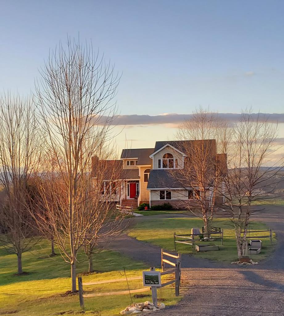 Nestled on 9+/- acres in the desirable Woodlawn area of Carroll County, this beautiful custom-built home offers a nice blend of comfort, craftsmanship, and breathtaking Blue Ridge Mountain views. The home features 3 bedrooms and 3.5 baths, highlighted by cathedral ceilings in the main living area, a stunning stone wood-burning fireplace and a sound system on both the main level and basement. The well-appointed kitchen showcases beautiful cabinetry and new appliances in 2022, while the spacious primary suite offers tray ceilings, a walk-in closet, and a luxurious bath. Two additional bedrooms and a full bath are located on the upper level. The lower level provides a large den with another wood-burning fireplace and full bath. Additional features include a new hot water heater in 2022, pressure tank and water filter with UV light, two-car attached garage, a detached one-car garage with extra storage, an outbuilding, and wiring for a generator hookup. Two energy efficient Bosch heat-pumps installed in 2022. Enjoy peaceful seclusion with some of the most spectacular views in the area, all while being conveniently located near shopping, schools, the hospital, New River and New River Trail, Crooked Creek Wildlife Management and Fee Fishing Area, the Blue Ridge Parkway and Music Center, and just minutes from Interstate 77. Call Today!