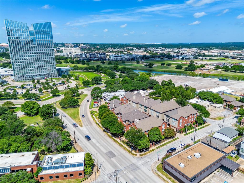 Professionally updated! Magazine-Ready townhome! Downtown Fort Worth and one block from our new City Hall and very near the Trinity River! Gloriously styled! Built by Perry Homes before urban living was even on the radar! Foresight is everything! Three story home with 3 spacious bedrooms, 2 and a half baths and a two car garage! Third floor outside deck with an additional 12 foot by 7 foot kitchen-bar with air conditioning! Elegant at every turn! Contemporary and traditional at the same time! The first floor boasts a custom fully temperature controlled wine cellar, two spacious bedrooms, full bath with custom updates including a large shower and new vanity and fixtures and a full sized laundry room! The second floor has been expanded to include approx. 33 additional sq ft from the double high entry below! AN ADDED HALF BATH, three living areas and three eating areas! Updated chef's style elegant kitchen with island and numerous cabinets and drawers! Double high fireplace room with custom white stone face, built-in cabinets, bookshelves! The third floor is the primary suite with separate tub and shower, tall ceilings, custom wallpaper from Italy on the bed wall and the outdoor deck and kitchen-small third living area! Corner home with North, East and South windows! Gated community with reasonable HOA dues! Walkable, easy access to the highways! Minutes from DFW Airport, Dallas and all in between! Million dollar feel for much less! Hurry on over to have a look!