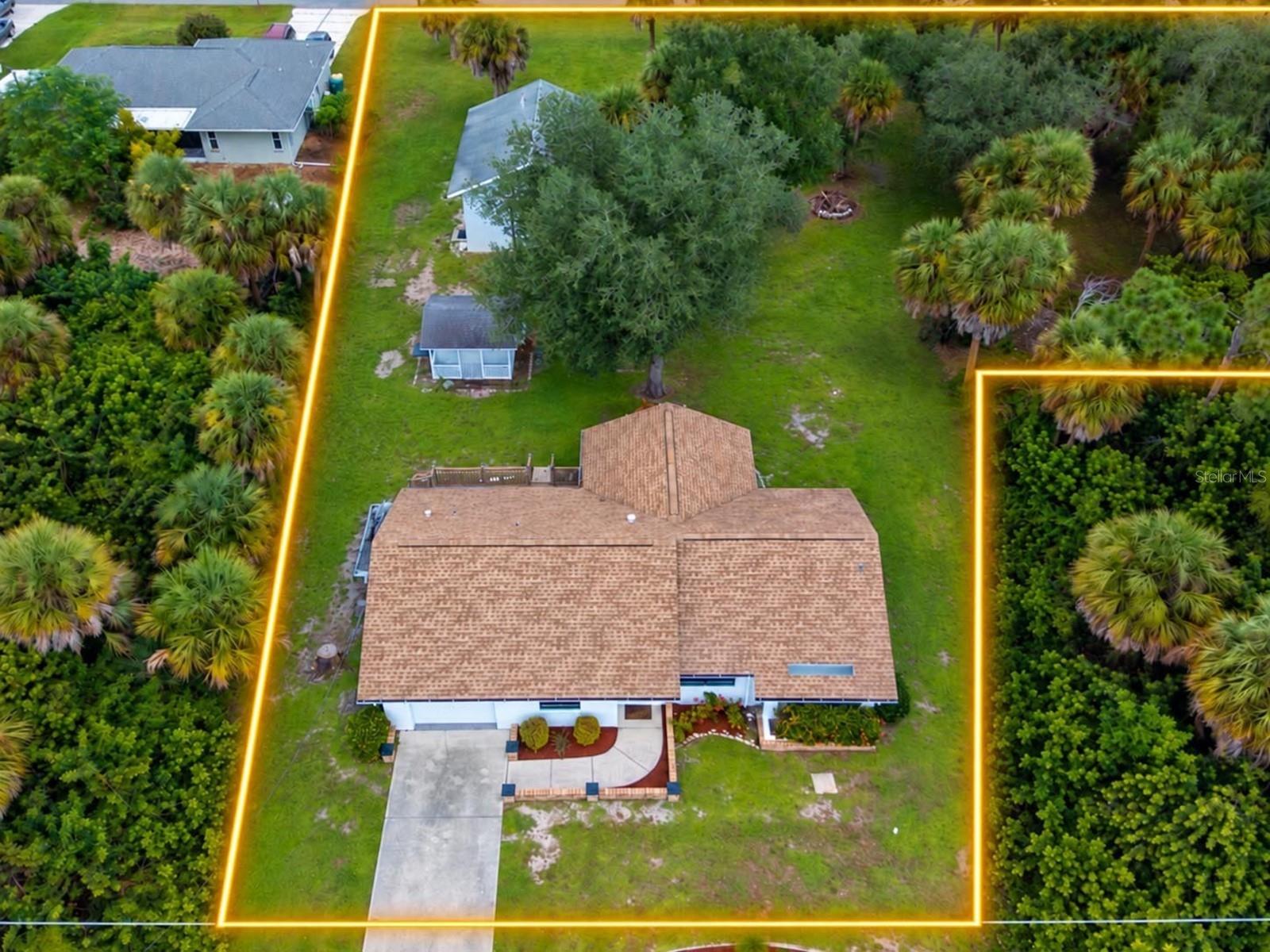 Virtually Staged. Set on an oversized nearly 30,000-square-foot lot with access from both Willmington Boulevard and Xavier Avenue, 11362 Willmington Boulevard offers a rare mix of comfortable living, serious storage and workshop space, all just minutes from parks, trails, golf, boating, and Gulf beaches. The main residence offers two  bedrooms, a Flex Space, and two full baths, with a third full bath in the detached garage/workshop. A freshly landscaped approach, exterior lighting, brick-lined walkway, and covered front porch create a welcoming arrival, while the home’s bright interior offers vaulted ceilings, laminate flooring, and an easy-flow layout for everyday living. The living room opens to a dining area with recessed lighting and an updated kitchen with white Shaker cabinets, granite countertops, stainless-steel appliances, built-in microwave, dishwasher, and a pass-through. A light-filled bay-window area offers flexible space for a home office, reading nook, or additional sitting area, with convenient access to the nearby bath. Plus a bonus room with French doors leading to the back expands the possibilities for a den, project room, or extra living space. The split-plan design places the primary suite apart from the secondary bedroom for added privacy. The second bedroom includes a walk-in closet, recessed lighting, custom trim, and nearby bath access with a tiled walk-in shower. The primary suite features a cedar-lined walk-in closet and an updated ensuite bath with granite and a handheld bidet sprayer. A laundry room with built-in storage and an attached one-car garage with a laundry sink and automatic opener add everyday convenience. Outside, a back deck overlooks the expansive grounds and leads to one of the property’s most compelling features: an impressive detached, oversized two-car garage and workshop. With concrete floors, a high-clearance main roll-up door, a second roll-up door, two man doors, vaulted ceilings, workshop cabinetry, counter space, utility sink, and a full bath with jetted soaking tub and tiled surround, it serves as the ultimate multipurpose space—perfect for car collectors, hobbyists, boat owners, or anyone seeking exceptional workshop and storage capabilities. A charming detached storage or hobby shed with a covered porch adds versatility, with a quaint playhouse feel and plenty of potential for gardening supplies or extra storage. The location enhances the lifestyle with Jennings Trailhead and Myakka State Forest close by, offering access for hiking, biking, horseback riding, wildlife viewing, and river access. Golfers can enjoy the Cove of Rotunda Golf Center, while Rotunda Community Park and Ann & Chuck Dever Regional Park add trails, sports courts, and playgrounds. Boaters and anglers have easy access to Stump Pass Marina, Ainger Creek Park, and a boat ramp, and Englewood Beach’s Gulf-front sand and sunsets are a short drive away. With an oversized lot, dual road access, attached garage, and a fully equipped detached garage workshop, plus proximity to boating, golf, parks, trails, and beaches, this property offers a level of versatility that’s hard to duplicate.