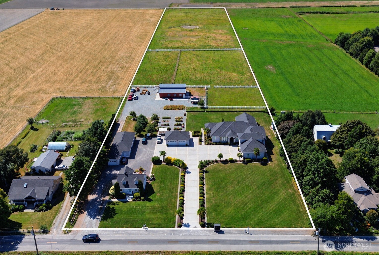 Rare Skagit Valley estate offering 8.79 picturesque acres, two residences, exceptional garage and shop space, and room for animals, gardening and multigenerational living. The 3,992-square-foot custom main residence was thoughtfully designed for luxurious main-level living, featuring an expansive primary suite, executive office and junior ensuite. The gourmet kitchen includes premium appliances, granite countertops, double ovens and a butler’s pantry. A separate three-bedroom ADU provides flexible accommodations for guests, extended living or potential rental income. Outside, discover a barn, pasture, greenhouse and orchard, plus a detached two-bay garage with a quarter bath and an additional four-bay garage/shop—ideal for vehicles, equipment, storage or hobbies. Altogether, the two residences provide approximately 5,430 square feet of combined living space in the heart of the Skagit Flats.
