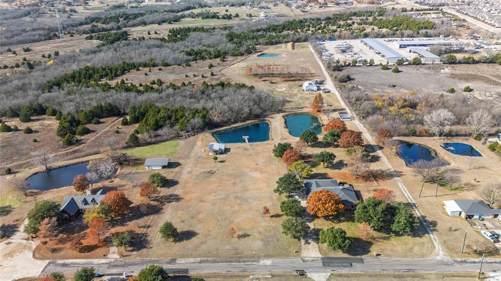 Prime 5.45 acres of commercial land ideally positioned adjacent to residential growth and outdoor recreation near Lake Lavon and Collin Park Marina. A large workshop comes with 1,152 square feet, spray foam insulation & SOLAR electric. Water and standard electricity also available. This versatile tract offers outstanding potential for development, owner-user operations, or long-term investment in a high-demand area. Excellent access and proximity to Lucas, Wylie and St. Paul make this a rare acreage opportunity. Existing metal building and pond provide endless possibilities. Buyer to verify zoning and permitted uses. Could be used for a landscaping or lawn business, water sport rentals, R.V. and boat or jet ski storage or parking, sporting good store, bait shop, food trucks, utility or service truck parking, a combination of these, or etc.