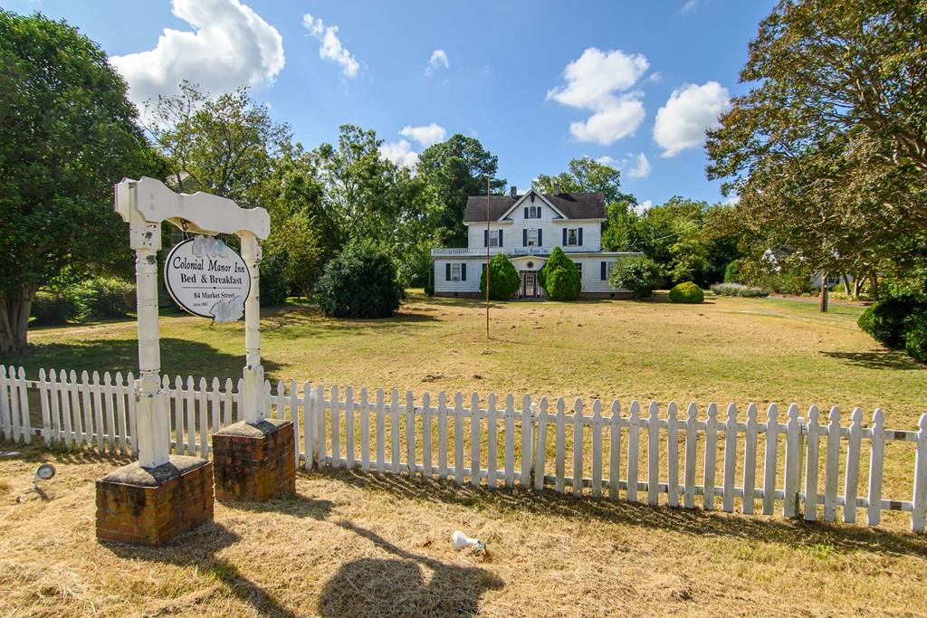 Step back in time with this rare opportunity to own the historic Colonial Manor Inn Bed & Breakfast nestled in the heart of Onancock. With original hardwood floors, antique fixtures, and cozy guest rooms, it offers a warm and inviting atmosphere. The Inn features a spacious dining room with a customtable, handcrafted from a tree on the property. 3 guest rooms on the first floor, 3 guest rooms on second floor, all with private bathrooms. 3rd floor private owner's quarters, previously rented as apartment/guest space for families. 1.8 acres of land with a carriage house that has potentialto be finished for additionalspace. This opportunity is ideal for aspiring innkeepers or seasoned hospitality professionals. Don't miss your chance to own a piece of history! Being sold As Is, TLC needed.