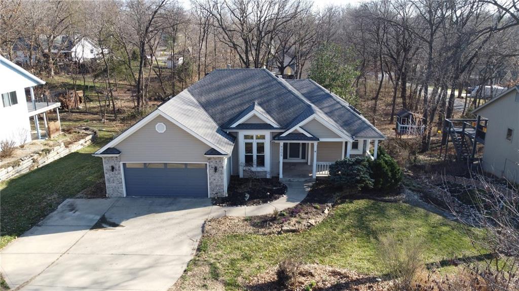 This well maintained home offers comfortable main level living with a spacious layout and a private backyard setting. A welcoming front porch leads into a bright interior featuring brand new carpet throughout. Just off the entry is a large formal dining room that flows into the living room with a cozy fireplace as the focal point.The primary bedroom is conveniently located near the living area and features a unique rustic accent wall. The updated primary bathroom includes a zero entry shower, rustic finishes, and a large walk in closet.The kitchen has been recently updated with new cabinetry and beautiful granite countertops and connects to a breakfast nook overlooking the backyard. A main level laundry room adds convenience to everyday living. Two additional bedrooms and a full bathroom complete the main floor.The walkout basement provides additional living space with a large recreation room that opens to a shaded and private backyard. The lower level also includes a spacious bedroom with double closets, a full bathroom, and a large storage room, offering excellent storage and flexibility.Weatherby Lake offers a true lake lifestyle with boating, fishing, sailing, and swimming, along with active community groups such as the Women’s Club, Fishing Club, and Yacht Club. Residents also enjoy popular events including Concerts in the Park, the July 4th Dinner and Dance, the St. Patrick’s celebration, and the annual BBQ Competition.Relax on the back deck, enjoy the peaceful backyard, and experience everything this vibrant lake community has to offer.