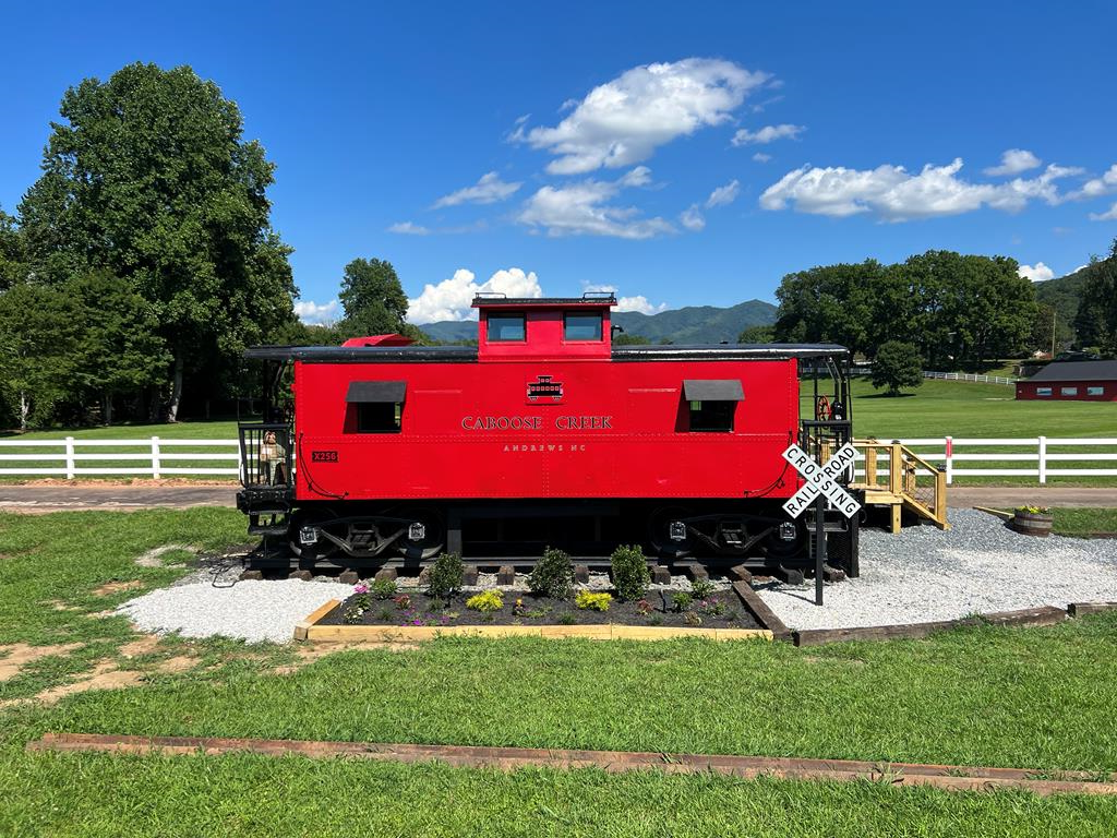 For Sale: Historic 1933 Red Caboose Airbnb on 2 Acres of Riverfront Bliss in Downtown Andrews. Step into a one-of-a-kind investment opportunity with this beautifully refurbished 1933 red caboose, a proven, highly successful Airbnb nestled on 2 acres of serene riverfront property in the heart of downtown Andrews. This charming, fully furnished retreat blends vintage allure with modern comforts, offering breathtaking mountain and pasture views that captivate guests year-round. Featuring a cozy one-bedroom, one-bathroom layout, this unique property boasts a distinctive cupola, a well-appointed partial kitchen, and two spacious outdoor decks perfect for soaking in the scenic surroundings. A private hot tub elevates the experience, making it a favorite for romantic getaways and tranquil escapes. The caboose is thoughtfully designed to maximize guest comfort while retaining its historic character, creating an unforgettable stay that keeps visitors coming back. Located within walking distance to downtown Andrews, guests enjoy easy access to local restaurants, breweries, and boutique shops, adding to the property's appeal. The 2-acre lot offers ample space for potential expansion or additional amenities, making this a versatile investment for continued Airbnb success or personal use. This turnkey property is a rare find, combining historic charm, modern upgrades, and a prime location with strong revenue potential. Don't miss your chance to own this iconic, income-generating gem surrounded by nature's finest views. Contact us today to schedule a viewing and seize this unique opportunity! One of the Owners is the listing Real Estate Agent