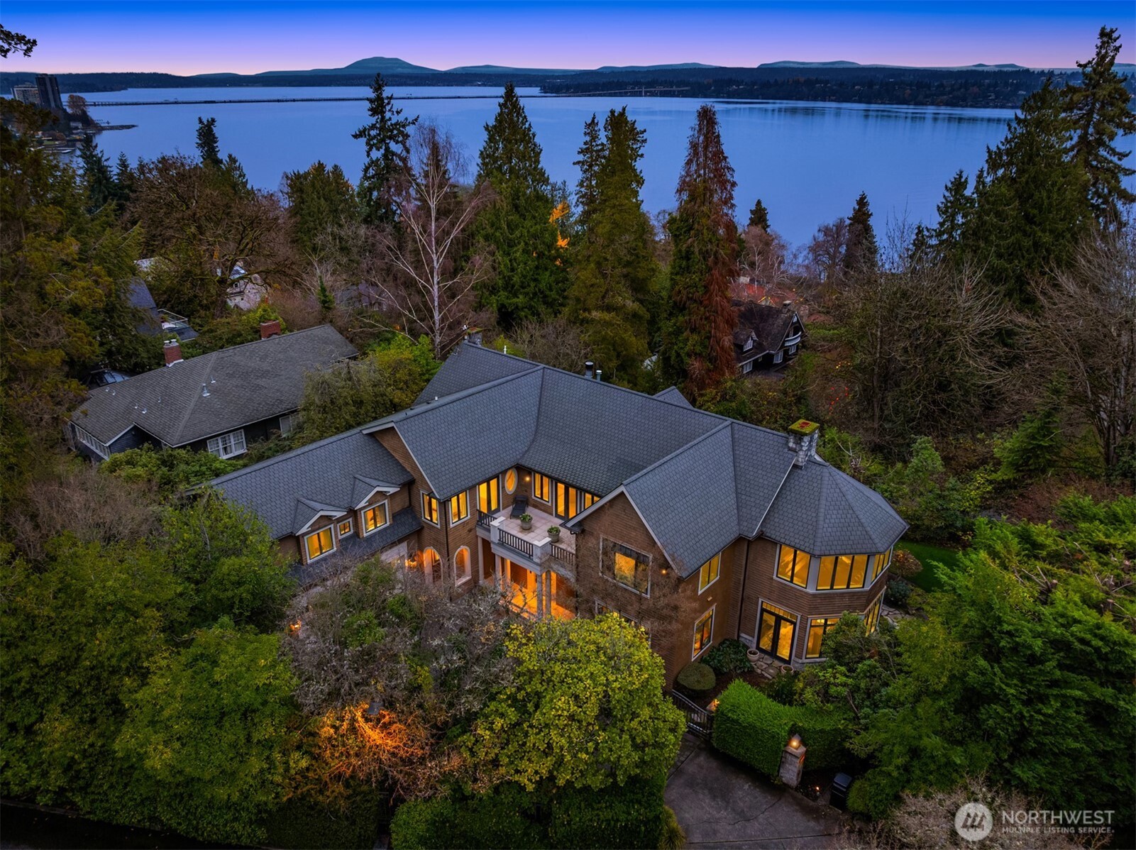 Perfectly located in Seattle’s favorite historic neighborhood, Denny Blaine, this 2001 Bob Maloney designed home accommodates modern lifestyles, yet offers classic design elements: shingled exterior, archways, paneled library, fine moldings, stone balcony, and four fireplaces. Enchanting Lake Washington & Bellevue skyline views. Beautiful materials, carefully maintained & very private! Stunning primary bedroom suite. Open floor plan ideal for gatherings of any size, and includes indoor/outdoor spaces, welcoming kitchen- family room, library, home-office, sun room, gym, recreation room, & play room. Sizeable, beautifully landscaped grounds. Choice location near villages of Leschi, Madrona and Madison Park!