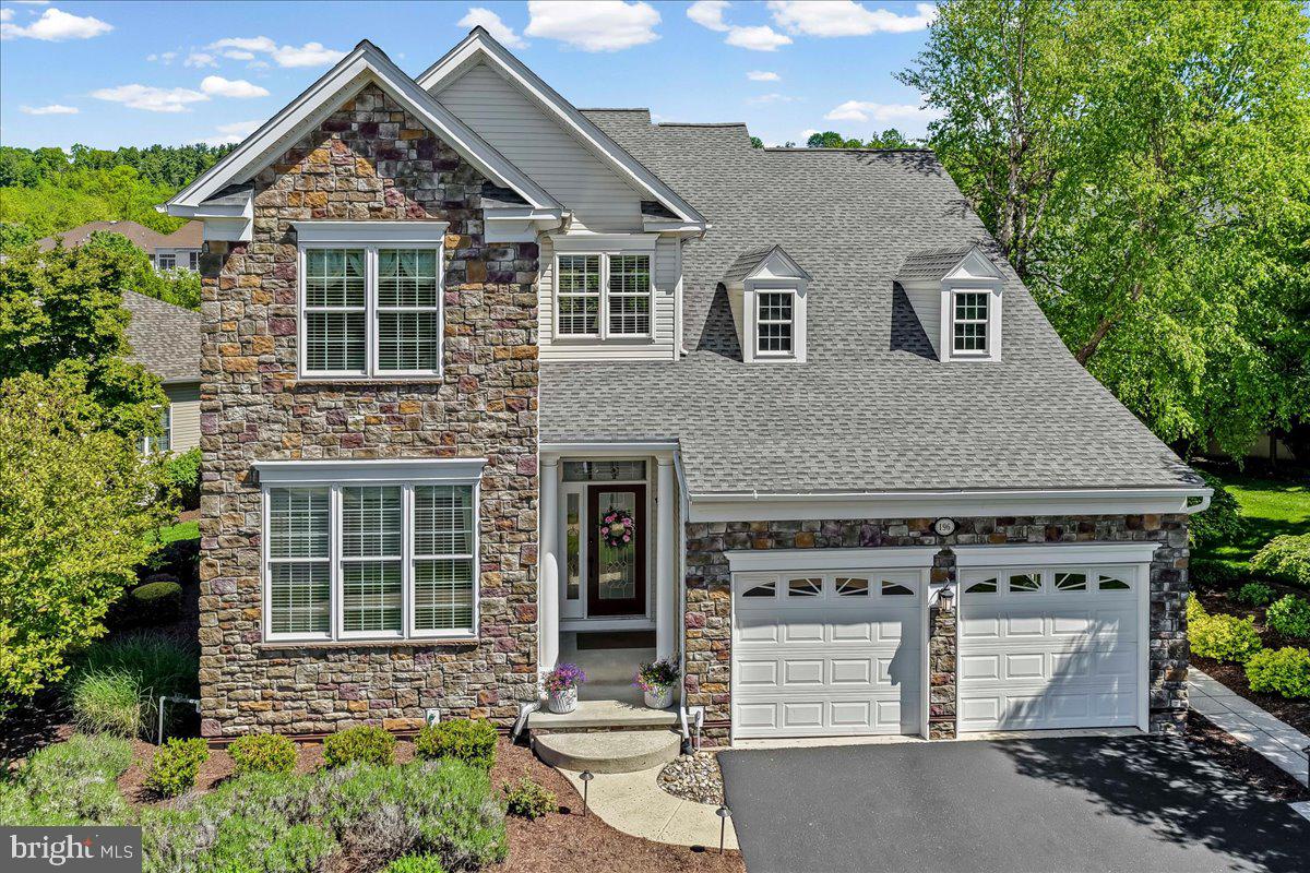 You don’t want to miss this rare opportunity to own the model home in the Regency at Providence, an award-winning 55+ community for active adults. This three-bedroom, four-bathroom Walden home offers premium upgrades throughout every area of the home. Enter a wide foyer that opens to a dramatic two-story great room with a coffered ceiling and custom chandelier overlooking a private oasis. A wall of windows showcases the covered rear porch and deck area. Adjacent to the great room is the upgraded gourmet kitchen, featuring high-end cabinets, recessed lighting, stainless steel appliances with double ovens, and a gas cooktop. Tall double doors lead from the great room to the first floor’s owner suite with an oversized tray ceiling, ceiling fan, and tall windows. A custom closet and deluxe bathroom with a seamless standing shower, double sinks,  complete the primary bedroom. The second bedroom on this level is situated across from the second full bathroom and a large storage closet. Upstairs, an extended  loft overlooks the great room and was designed with care as a home office, complete with built-in cabinets, bookcase, and a large desk. The third bedroom and full bath are perfect for hosting friends and family. This home’s lower level is fully finished with high-end model upgrades from the builder. Arched ceilings separate living and entertaining areas, along with a full bar complete with a beverage refrigerator. There is also a full bathroom with a shower on this floor. The yard is professionally landscaped with a stone patio and custom landscaping, an irrigation system, outdoor lighting, a railing, and roof enhancements.  The premium lot backs to open space with a view of the gazebo and is located close to the clubhouse, pool and tennis/pickleball courts.  Conveniently located just minutes from the vibrant dining, shopping and entertainment of Phoenixville, the Oaks shopping  area, Wegmans, and major commuter routes. This is truly an exceptional home.