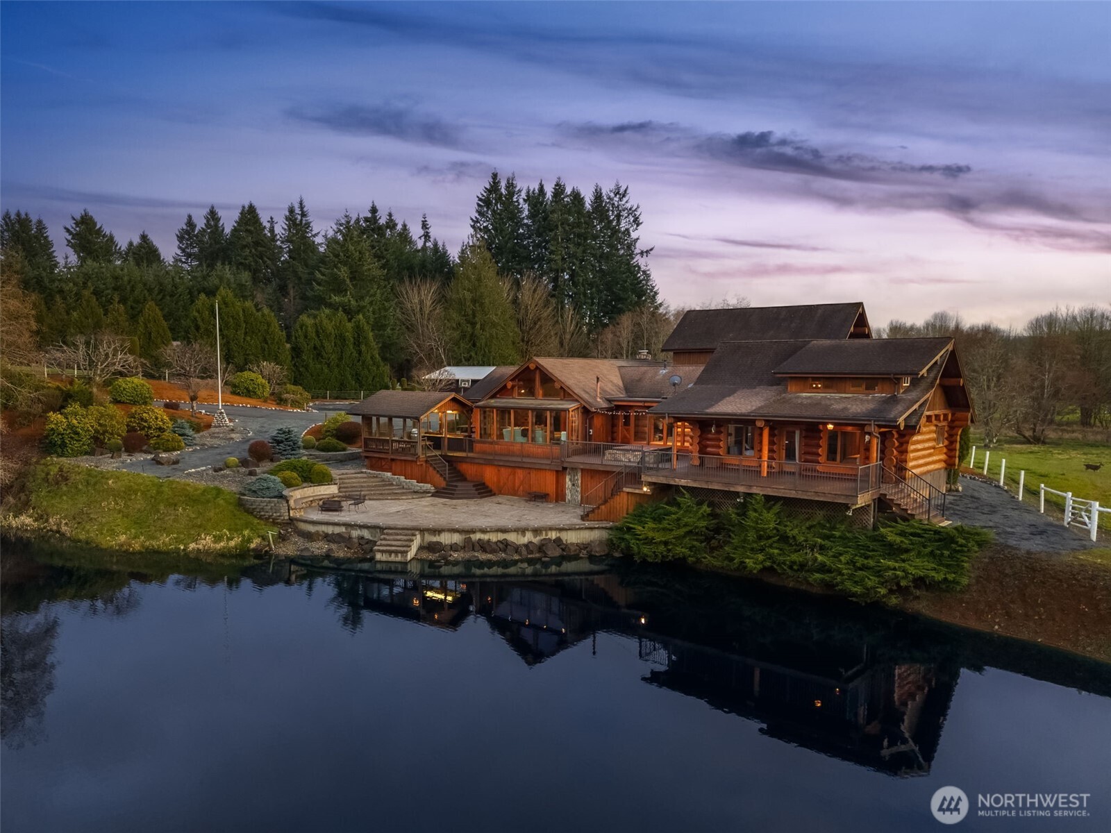 Custom log home on acreage in Chehalis featuring a private spring-fed lake and over 21 acres of usable land. This 3 bedroom home offers a functional layout with vaulted ceilings, exposed log construction, and multiple fireplaces that anchor the living spaces. The primary suite includes a private loft area, creating additional flexibility for office or retreat use.    Upstairs, a large bonus or recreation room with a Murphy bed opens to a balcony overlooking the acreage and surrounding countryside. The kitchen connects naturally to the main living area, supporting everyday use and gatherings while maintaining views of the property.    Recent updates include a newly sealed driveway, new exterior doors, and new French doors in the upstairs bonus room. The exterior logs are scheduled to be sealed this summer, supporting ongoing maintenance and preservation of the home. The laundry room includes a dedicated pet washing station for added functionality.    The land offers open pasture and usable ground suitable for livestock, recreation, or future improvements. The private lake provides a focal point for the property and supports fishing, swimming, and outdoor enjoyment. Located near Adna with access to Interstate 5, this property balances rural privacy with regional connectivity.