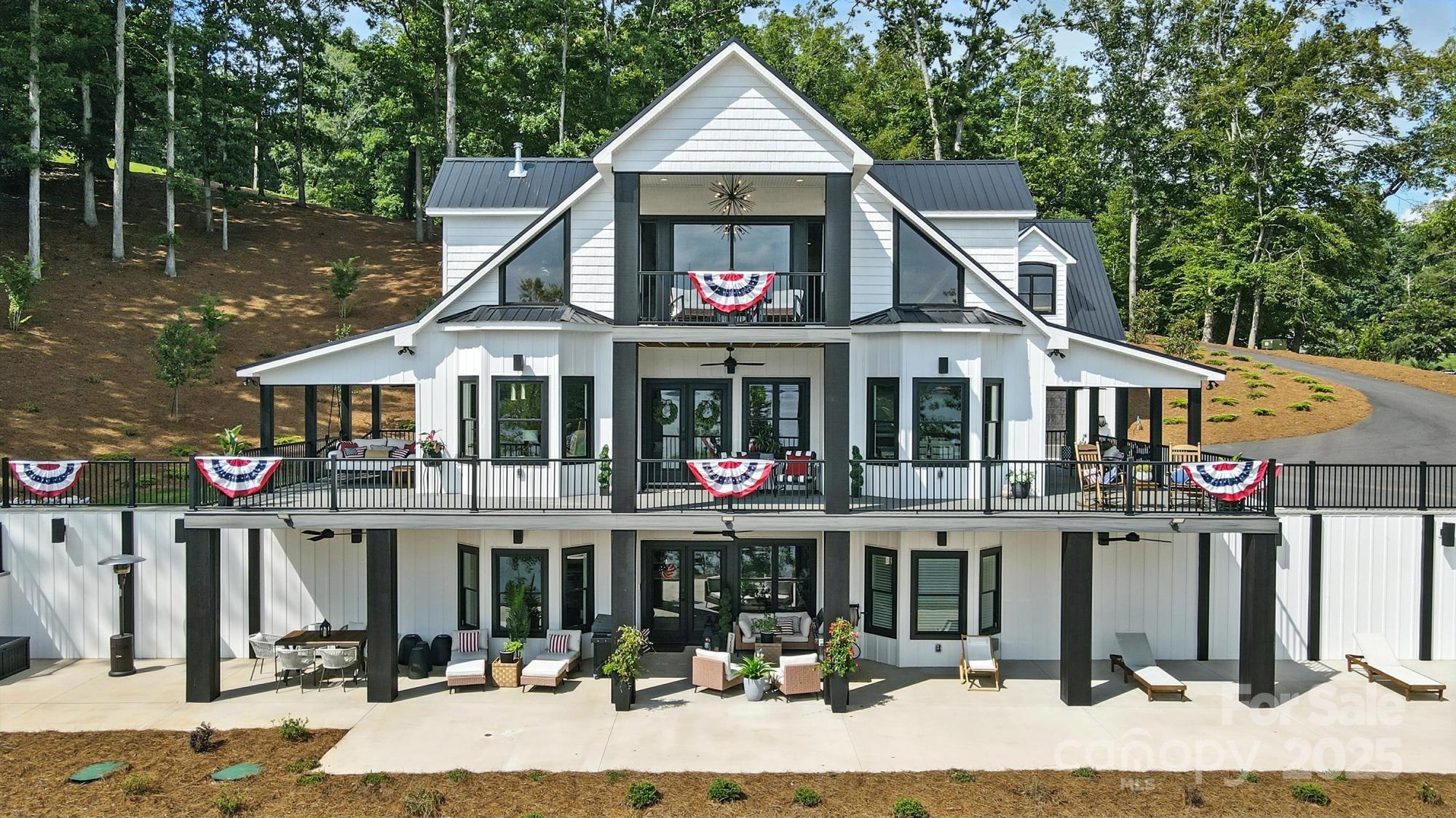 Welcome to your dream home on Lake Tillery! This home offers sweeping views of the Uwharrie National Forest, perfect for peaceful mornings and unforgettable sunsets. Every detail has been designed with luxury and convenience in mind. This home offers a gourmet kitchen with custom cabinetry, quartz countertops, under counter lighting, smart Frigidaire professional freestanding column refrigerator, touchless sink faucets, air controls for overhead island lighting and disposal. Custom cabinetry and quartz counter tops throughout kitchen, laundry room, bathrooms and fireplace. Spa like primary bath with freestanding soaking tub, walk in glass shower featuring double shower heads, body spray system, and mounted jets. Laundry room with built in bench and coat rack. Tankless hot water heater. Finished basement with custom antique glass bar cabinetry. Wrap around porch with composite trex decking and a cozy bed swing. This home is the perfect blend of serene lakefront living.