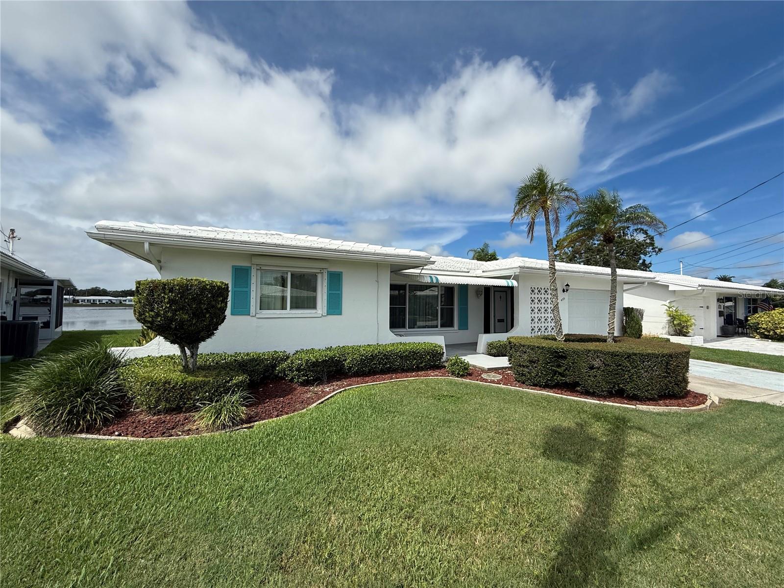 Lakefront Living in The Mainlands  55+ Community
Discover this beautifully maintained 2-bedroom, 2-bath lakefront home offering nearly 1,700 sq. ft. of living space plus an oversized 1-car garage. Move-in ready, the inviting floor plan with beautiful water views. 
The central kitchen features wood cabinets, deep pull-out drawers, granite countertop, and newer appliances. Both bathrooms are stylishly updated, and the home includes impact windows, storm shutters, and newer garage doors for peace of mind.
This home comes fully furnished, including a high-quality bedroom set with the sleep number bed and an electric fireplace in the Florida room. Bedrooms are generously sized with ample closet space, and importantly—this property did not flood in recent storms.
Living in The Mainlands of Tamarac by the Gulf means enjoying a vibrant 55+ lifestyle. Built around an 18-hole public golf course, the community offers 7 clubhouses, heated pools, shuffleboard, and endless activities. The HOA takes care of it all—roof repair/replacement, cable, internet, water, sewer, trash, irrigation, lawn care, and exterior paint—ensuring truly worry-free living.
Perfectly located in Pinellas Park, you’ll be close to shopping, dining, both Tampa and St. Pete airports, and just 10–12 miles from the Gulf beaches. Schedule your showing today and experience the best of lakefront Florida living! BEST PRICED waterfront home in the community!