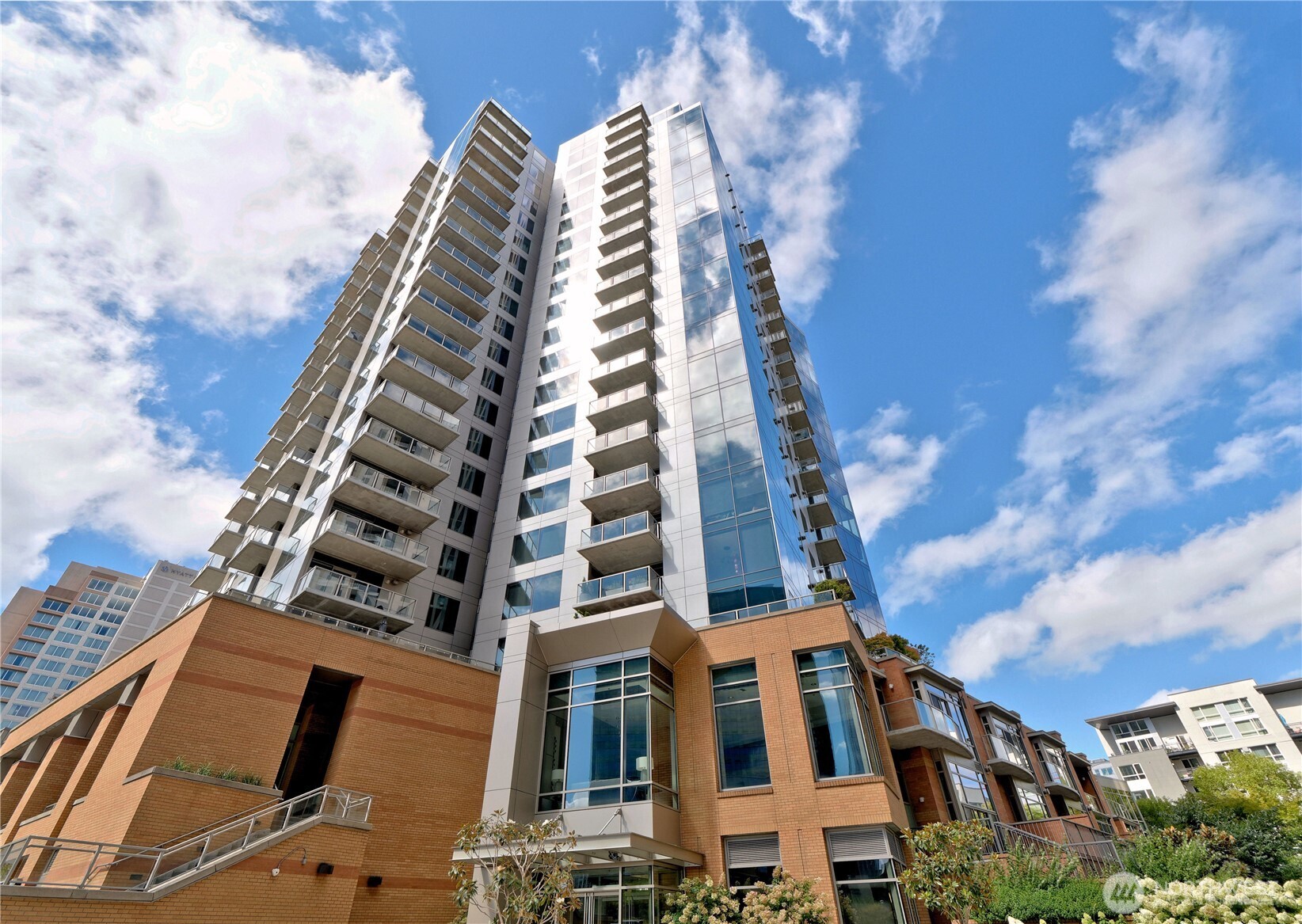 Fabulous light-filled Corner Unit in Washington Square Towers. Two bedrooms plus den offers space for every flexible living. Quality Kitchen Aid appliances, gas cooktop, beautiful decorative tile are just some of the features of the well-appointed kitchen. Livingroom features an elegant fireplace and floor to ceiling glass windows with views of Bellevue. You can also enjoy the fireplace from Primary Bedroom which also has a generous walk-in closet. Primary Bathroom offers a large tub, glass enclosed shower, and dual sinks. Granite countertops thoughout. The home also features a large balcony and a bright open den/office with views. The unit is in Tower 1 with the Fitness Gym, Spa, and Community party and game room on the 3rd floor. Two parking spaces sid-by-side are included. Great  central location gives walkable access to all that downtown Bellevue has to offer.