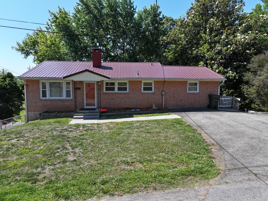 Brick ranch home located in the heart of  Patrick County, Virginia, at 101 Hillcrest Ct, Stuart, VA. This property offers comfortable one-level living with additional finished space in the walk-out basement, making it ideal for families, retirees, or anyone seeking small-town charm. The main level features a kitchen, living room, dining room with - bay window, three bedrooms, and a full bath. Double-pane, double-hung windows provide energy efficiency and natural light throughout the home.  The partially finished walk-out basement with a family room featuring a fireplace and wall-mounted propane heater — perfect for relaxing or entertaining year-round. This level also includes a utility area with a bathroom, washer and dryer and a storage room. Enjoy the large back deck for morning coffee, reading or just relaxing and enjoying country life.   Recent improvements include a new roof installed in September 2021. Fenced in back yard for children or animals and in the basement - the family room - the flooring was replaced with  interlocking PVC Plastic.  Fronts on paved road. Paved driveway. Conveniently located near schools, churches, banks, shopping, public library, and local restaurants, this home combines country living with easy access to everyday amenities. Opening of the hospital in Stuart, VA in 2026 - Five minutes to Hospital in Stuart, VA.  20 minutes to Meadows of Dan, VA.  30 minutes to Martinsville, VA.  30 Minutes to Floyd, VA. 30 minutes to Mt. Airy, NC and 1 hour to Winston Salem, NC.   Home is move in Ready!