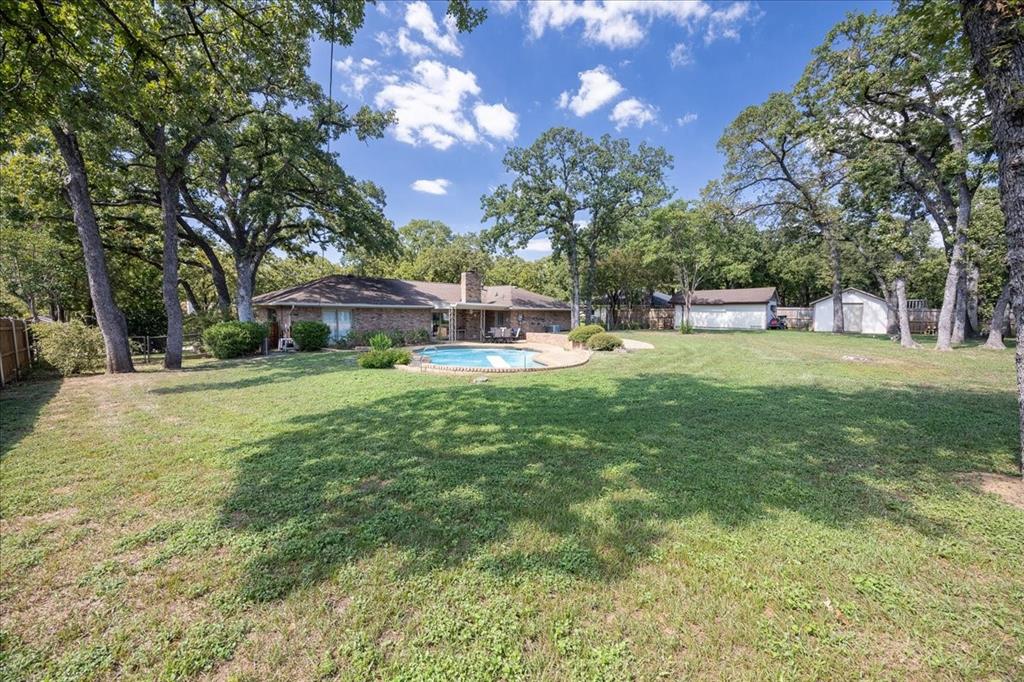 Discover an extraordinary gem in the heart of Colleyville’s prestigious Brighton Oaks neighborhood! Nestled on a sprawling .54-acre lot adorned with majestic mature oak trees, 3909 Allendale offers timeless charm and modern comfort. This inviting 3-bedroom, 2.5-bathroom home boasts expansive walk-in closets and a cozy wood-burning fireplace, perfect for creating lasting memories.
Step outside to your private oasis—a generously sized backyard enveloped by full privacy fencing, featuring a sparkling in-ground pool, a covered patio for al fresco dining, a convenient storage shed, and a dedicated boat storage house. This rare find blends serene suburban living with unparalleled convenience, making it the perfect retreat for those seeking both elegance and functionality in one of Colleyville’s most sought-after communities.