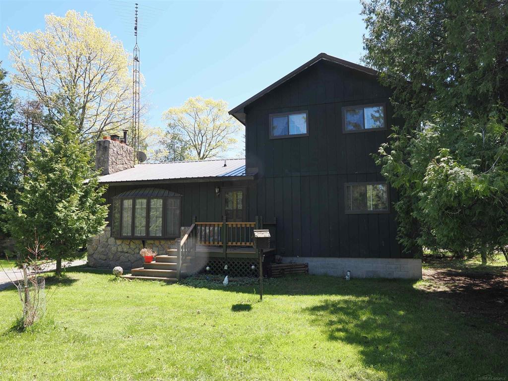 This high-quality 3"“4 bedroom, 2-bath home is in an incredible location, bordered by state land on one side, a 133-acre township park with 9,632 feet of Lake Huron frontage on another, and 150 feet of frontage on a canal leading to Lake Huron.  The home was built to an exceptionally high standard and has been well maintained over the years, likely requiring only cosmetic updates to suit the new owner's taste. The spacious kitchen features a commercial-grade stove and ample storage. The main floor includes a master suite with its own sliding door leading to a private deck. Upstairs, there are two additional bedrooms. There is also a fourth bedroom or office area on the main floor. The main-floor bathroom has been recently updated.  A large sunken living room is centered around a fireplace, creating a cozy and inviting space.  Outside, the property includes a detached two-car garage equipped with a wood-burning furnace and 220V electric, a smoker for preparing fresh fish, and a garden shed. An adjoining lot, which is included with the property, doubles the land area and features an old cottage in disrepair. While the wood addition will likely need to be torn down and removed, the original cinder block structure appears solid, with no visible cracks or failures in the block and no apparent roof leaks. This space could be converted into a guest house, game room, or storage building, or removed to expand the yard.  Kayaking from the property or the nearby township park offers access to incredible sites, including the Lake Huron sinkholes, Thunder Bay Island and lighthouse, parts of the Michigan Islands National Wildlife Refuge, the Monohansett shipwreck in just 18 feet of water, and the much deeper Pewabic shipwreck. During high-water cycles, boat traffic is possible on the canal. During low-water cycles it is great for wildlife.  The township park features developed trails for walking or jogging, while the state land remains completely undeveloped, offering opportunities for hunting and outdoor recreation. Despite i