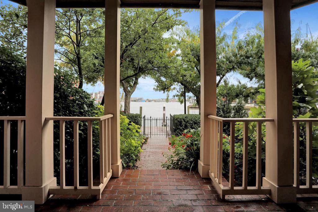 When it is all about location, can it get any better than this. Live the dream in this historic Fells Point waterfront townhome. This iconic condominium townhouse development, features four houses that front the harbor and four that front Fell Street. Harbor's Edge is the name of the development. This house is the smallest of the four that front the water but it is not without its charms. It consists of 1770 Square feet. It has 2 bedrooms, 1 full bathroom and 1 half bathroom. The house has natural wood, oak floors, through out with creative ceramic tile in the bathrooms. The second floor living area is an open concept where living, dining and kitchen spaces combine and open to front and rear balconies. The garage opens into a hallway and a nook that ideally serves as a home office with a water view. The front yard faces the water and a rear yard includes a brick parking pad with access to the rear entry,1car garage. The development is reached by a driveway off Fell Street. Additional exterior features include a front porch, a front balcony as well as a rear balcony/deck ideal for dining.  Incredible views can be had from the level one, the office, level 2 the living area and level 3 the bedroom level. Listing agent must accompany all showings. Please allow for a tenant notification of 24 hours.